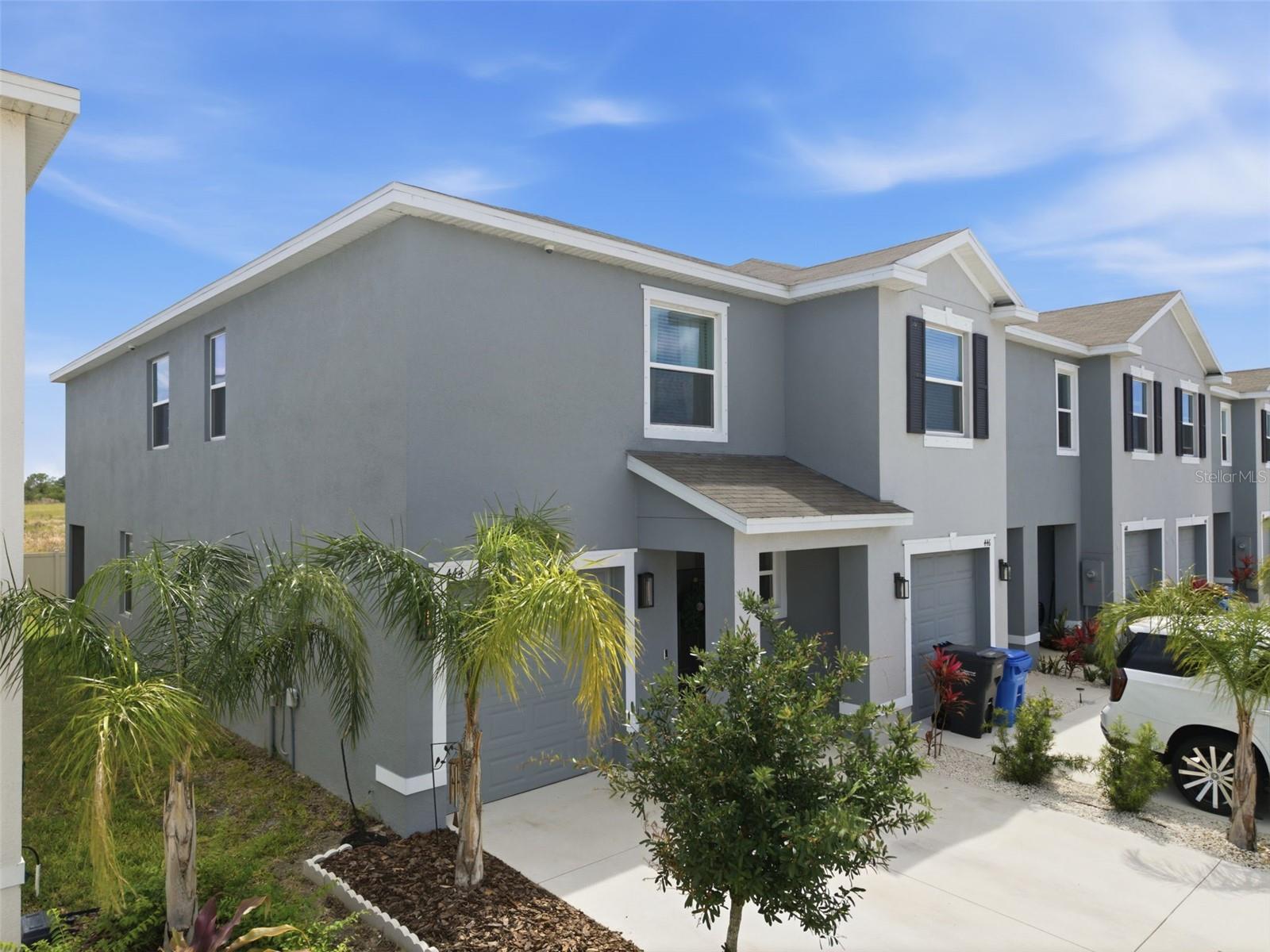 Why Wait to Build? Move right into this beautifully maintained 2024 end-unit townhome, where modern design, thoughtful upgrades, and an unbeatable Apollo Beach location come together. Better than new and truly move-in ready, this home offers the perfect combination of style, comfort, and peace of mind.
From the moment you step inside, you'll appreciate the bright, open layout enhanced by soaring ceilings, abundant natural light from the additional end-unit windows, and elegant tile flooring throughout the main living areas. The gourmet kitchen is designed for both everyday living and entertaining, featuring quartz countertops, stainless steel appliances, contemporary cabinetry, and an inviting flow into the spacious dining and living areas.
Step outside to the screened lanai, an ideal retreat for enjoying your morning coffee, unwinding after a long day, or entertaining friends while enjoying Florida's beautiful weather.
The spacious primary suite serves as a private sanctuary with two walk-in closets, a luxurious ensuite bath, and an adjoining flex room that easily adapts to your lifestyle as a home office, fitness space, nursery, reading room, or even a potential fourth bedroom. Two additional bedrooms provide generous space for family or guests.
Designed with convenience and security in mind, the home includes a professionally installed security system, smart home technology, and pre-wiring for a generator—providing added confidence during Florida's storm season.
Residents enjoy low-maintenance living with HOA fees covering water, sewer, and grounds maintenance, while community amenities include a sparkling swimming pool and playground.
Perfectly situated just minutes from shopping, dining, waterfront restaurants, and some of Apollo Beach's most popular attractions—including Circles Waterfront Grill, Apollo Beach Nature Park, and Wolf Branch Creek Preserve—you'll also enjoy easy access to boating, fishing, and all the recreation Tampa Bay has to offer.
Whether you're searching for your primary residence, a seasonal retreat, or a low-maintenance investment in one of the area's fastest-growing communities, this exceptional home delivers outstanding value, modern construction, and the Florida lifestyle you've been looking for.