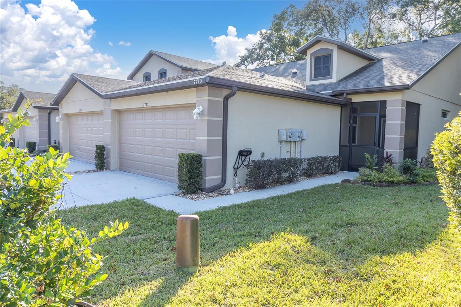 Imagine coming home to a place where life simply feels a little easier. At 7715 Dawson Creek Lane, you'll find more than just a beautifully maintained villa-you'll find the kind of home that gives you more time to enjoy life and less time worrying about maintaining it. Built in 2020 and lovingly cared for, this move-in ready one-story end-unit villa is situated on a quiet dead-end street in the gated Edgewater community at River Ridge Country Club. Pet friendly community, bring your furry friends! Step onto the screened lanai with your morning coffee and take in the peaceful conservation views. With no rear neighbors, the backdrop is one of nature, creating a sense of privacy that is hard to find. Inside, the thoughtfully designed split-floor plan offers 2 bedrooms, 2 baths plus a versatile office that is perfect for working from home, welcoming overnight guests, or enjoying your favorite hobbies. High ceilings and four solar tube lights fill the home with natural light making every room feel bright, open and inviting.  The kitchen is both beautiful and practical, featuring granite countertops, a tiled backsplash, breakfast bar, slide-out shelving in the lower cabinets and like-new stainless steel appliances. The kitchen opens seamlessly to the living and dining areas making it just as comfortable for quiet evenings as it is gathering with family and friends. At the end of the day retreat to the private Primary Suite overlooking the wooded conservation area. Tray ceilings, walk-in closet and a large Primary Bath with dual sink vanity and walk-in shower create a comfortable space to unwind. Extra wide hallways, no interior or exterior steps, hurricane impact windows throughout and luxury vinyl flooring in the living areas, tile in the baths, leaf guards, and screened lanais in both the font and rear add to the homes comfort, convenience and peace of mind. The roomy two-car garage provides plenty of space for vehicles, storage or weekend projects. One of the things you'll appreciate most is how easy this home is to own. The low HOA fee of just $260/mo. covers exterior maintenance, roof, exterior paint, lawn care, irrigation, fertilization, pest control, trash service and gated entry. Whether you're a year-round resident, seasonal home owner, frequent traveler, or simply someone who would rather spend weekends enjoying life than maintain a home, you'll appreciate the ability to lock the door and leave. It's the perfect Florida retreat for those seeking a truly turn-key, low-maintenance, lifestyle. Conveniently located near shopping, restaurants, medical care, airports, beaches, highly rated schools, Starkey Wilderness Preserve, and very close to the Sun Coast Parkway via the Ridge Road extension, this home offers easy access to everything you need while still providing a peaceful place to come home to. At just $265,900, this exceptional villa presents an incredible opportunity to own a nearly new home, with a two-car garage, conservation views, modern features and a truly low-maintenance lifestyle. If you've been searching for more freedom, more privacy, and more value for your money, 7715 Dawson Creek Lane may be exactly what you've been waiting for!
