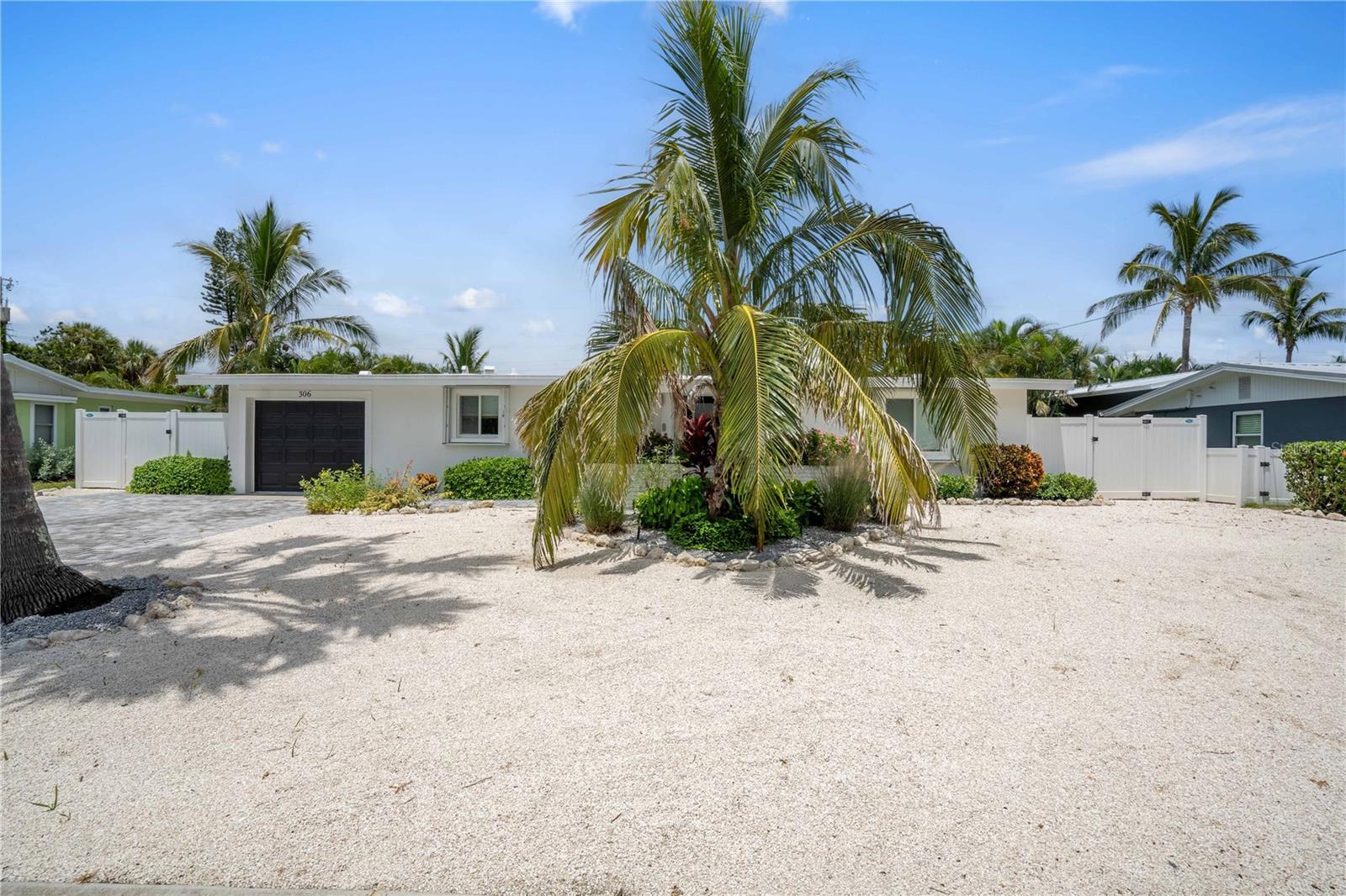 Welcome to LivinGood, a thoughtfully redesigned beach home where effortless indoor-outdoor living shines. Slide open the glass doors and step directly into your private pool and entertainment area, keeping family and guests seamlessly connected without the need to climb a single set of stairs. This completely remodeled 3-bedroom, 2-bath pool home is offered turnkey furnished and blends modern luxury with laid-back beachside charm, with beach access just minutes away. Inside, impeccable craftsmanship is highlighted by restored terrazzo floors, a gourmet kitchen with quartz countertops, all-wood custom cabinetry, and a high-end gas range, a split floor plan for added privacy, and fully updated bathrooms with modern finishes. The home is equipped with a tankless water heater, two mini-split units, a top-of-the-line Trane A/C system, and an EV charger for comfort and efficiency. Outdoors, enjoy a custom high-end pool built by one of the top pool builders on AMI, a screened-in lanai, lush low-maintenance turf, a putting green, built-in closets, ample storage, and close proximity to the island’s best dining and shopping. Everything has been thoughtfully designed with the end user in mind. Schedule your private showing today!