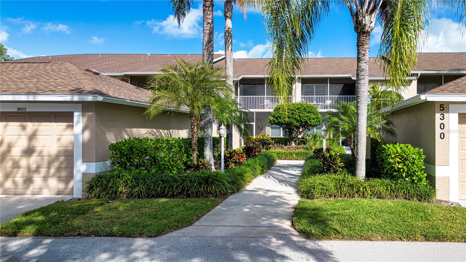 This is a first floor, corner unit ABBEY floor plan: the largest of the Veranda Condos at 1684 square feet overlooking the green of the Signature 14th Island Hole.   In addition to the standard floor plan, this unit has a wet bar in the Living Room and a built in desk/bookcase/ computer unit in the Den and is offered fully turnkey furnished, just waiting for exactly the right person to come along and upgrade with their own personal touch - a blank slate to make your designer alter ego come to fruition.  it's all about Location, Location, Location and in a gated golfing community.  Heritage Oaks Golf and Country Club is a 500 acre, Audubon Certified community which features an 18-hole, Azinger-Lewis designed championship golf course, complemented by a Master's style Pro Shop. The recently remodeled clubhouse features the expanded 19th Hole Bar & Grille with several other smaller dining rooms for private parties, a multi-use room, card room, and an outdoor Al Fresco dining area.  In addition, the club's extensive amenities include 4 Har-Tru surface, lighted tennis courts, a newly remodeled equipped fitness facility staffed by a full-time director and guest instructors who provide numerous classes.  There are five pools, including the main, Jr Olympic pool and Spa, disbursed throughout the community. The condo's one car detached garage, in addition to the car or golf cart, has some extra storage space.  Driving to the other venues, Sarasota is usually within twenty minutes: the Siesta Key beach, the downtown area, the Ringling Bridge to St. Armand's Circle, Longboat Key, and Anna Maria Island; Venice to the south and talc, sandy beaches along the entire coastline. This is not just a house on the street: Heritage Oaks has an active lifestyle with a plethora of physical amenities, but also many social activities in which to participate.  Come join un in Sunny Sarasota and live the country club experience.