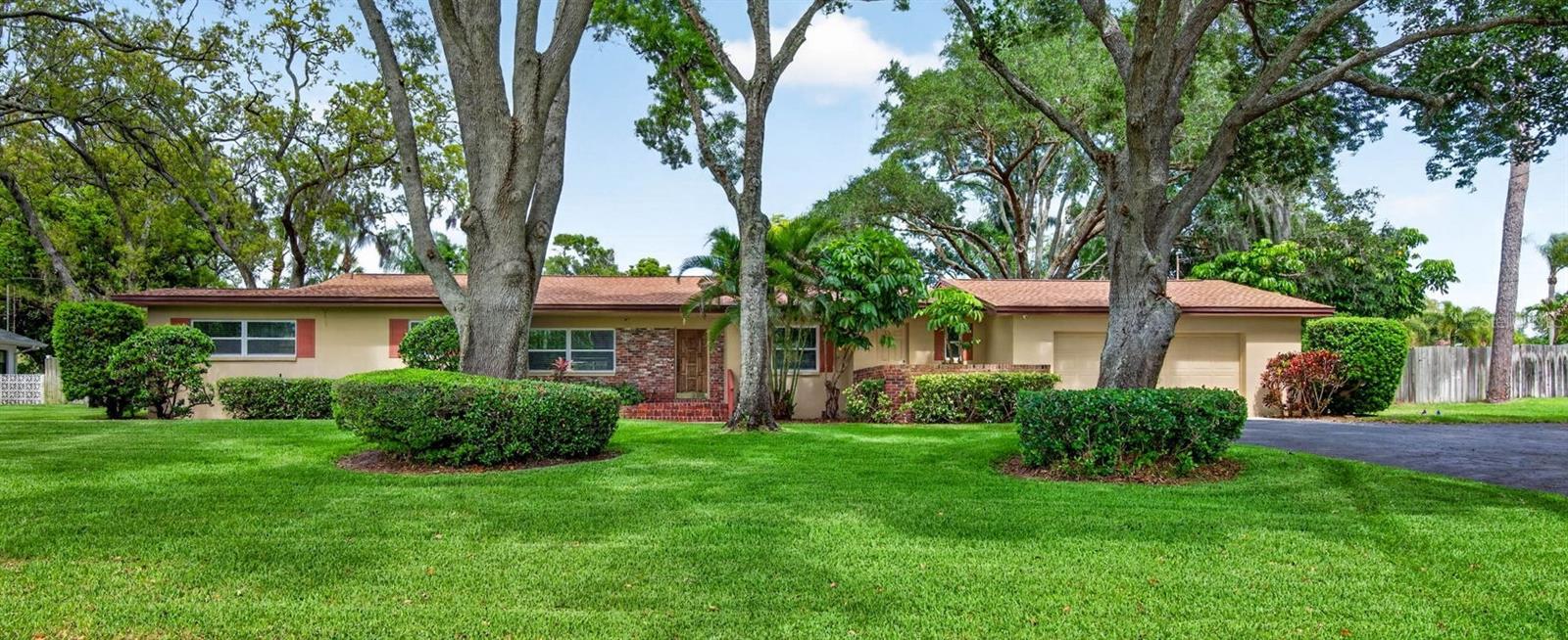A truly exceptioinal find in a highly desired school district, featuring a rare and spacious 3/4 acre manicured lot! This custom home was crafted with pride in workmanship and quality. Situated on a high and dry estate with NO FLOOD zone yet just a bike ride away from the beach! Recent updates include a new roof (2023), New HVAC, New hot water heater, New plumbing, new electrical, luxury vinyl plank flooring and travertine, updated windows, fresh epoxy flooring in the large 2 car garage, gorgeous granite kitchen countertops, newer stainless steel appliances, a dedicated laundry room, a heated and cooled Florida room with a wood burning fireplace, 3 bedrooms and 3 bathrooms, dedicated dining areas that can also serve as flex/office space, a sparkling inground screened-in pool, and a tropical oasis yard that gives a private resort vibe. The outdoor space was thoughtfully designed for comfort, relaxation and entertainment. This gem is nestled away in a private community yet no HOA. It is conveniently close to all that Dunedin and Palm Harbor have to offer! Nearby you'll find the Pinellas Trail for walking, jogging, biking, near nature and scenic views. Within close proximity to the Dunedin Causeway Beaches, Honeymoon Island, golfing, fishing, waterfront dining, marinas, hospitals, breweries, dog-friendly venues, boutiques, parks, shopping, and so much more. This gorgeous gem is just 21 miles to the Tampa airport. Schedule your private tour today!