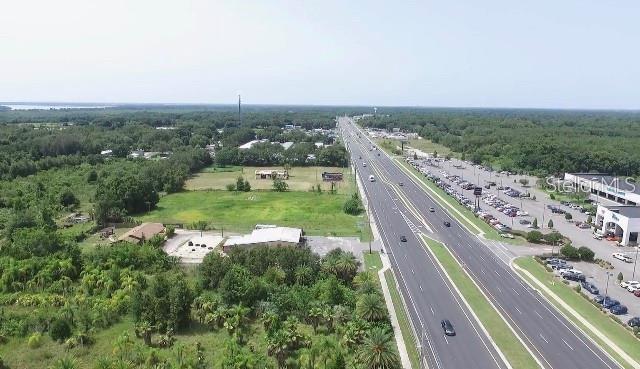 Under contract-accepting backup offers. 15+acres on Hwy 441/27 corner of Shadow Hill Drive in the city of Fruitland Park. Corner location, high traffic count, city utilities and great road frontage Zoned C-2, General Commercial. 350 Feet of frontage on the highway. Corridor to The Villages. The Villages is one of the largest retirement communities in Florida. All combined The Villages cover more than 80 square miles, which is equivalent to more than 51,200 acres. Amazingly, The Villages is still growing, and is one of the fastest growing cities in Florida. The Villages community is so large that it includes multiple zip codes and is located in three separate county jurisdictions: Lake County, Sumter County and Marion County. Owner financing with very attractive terms, up to 30 year amortization. The entire property is fenced and a 10' well.