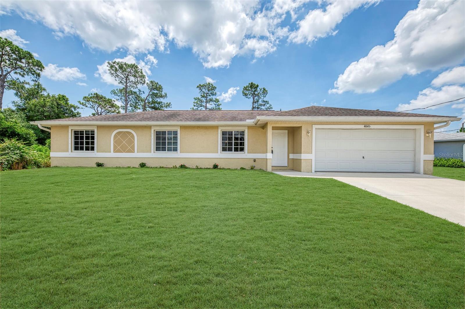 Great 2015-built 3-bedroom, 2-bath home with a 2-car garage and a fenced backyard, offering comfort, style, and convenience in one attractive package. From the moment you step inside, you'll appreciate the bright and open layout designed for easy everyday living. The spacious living room features soaring cathedral ceilings and recessed lighting, creating an inviting atmosphere that feels both airy and warm. Tile flooring runs throughout the entire home, adding a clean, modern look while making maintenance simple. The dining room is perfectly positioned for gatherings and daily meals, with sliding glass doors that open to the screened lanai. This relaxing outdoor space is ideal for enjoying morning coffee, evening breezes, or outdoor dining while staying protected from the elements. The galley kitchen is both functional and appealing, featuring wood cabinetry, granite countertops, a glass-top stove, and a whole-house reverse osmosis system along with an additional under-sink reverse osmosis system for added water quality and convenience. The primary bedroom offers a comfortable retreat with dual closets and a ceiling fan for year-round comfort. The primary bathroom features a wood vanity with a granite countertop and a Roman shower, providing a touch of elegance to the space. The guest bedrooms are generously sized and include ceiling fans and built-in closets, offering plenty of storage. The guest bathroom includes a convenient tub and shower combination. Step outside to the fenced backyard, providing privacy and room to relax, entertain, or enjoy outdoor activities. Additional features include hurricane shutters for added peace of mind and the valuable benefit of being located outside of a flood zone. This centrally located home places you close to schools, shopping, restaurants, and everyday conveniences. Whether you're searching for a starter home, looking to downsize, seeking a rental investment opportunity, or wanting a winter retreat, this property checks all the boxes. With its desirable features, practical layout, and excellent location, this home is ready to impress. Call today to schedule your private tour and see everything this beautiful home has to offer!