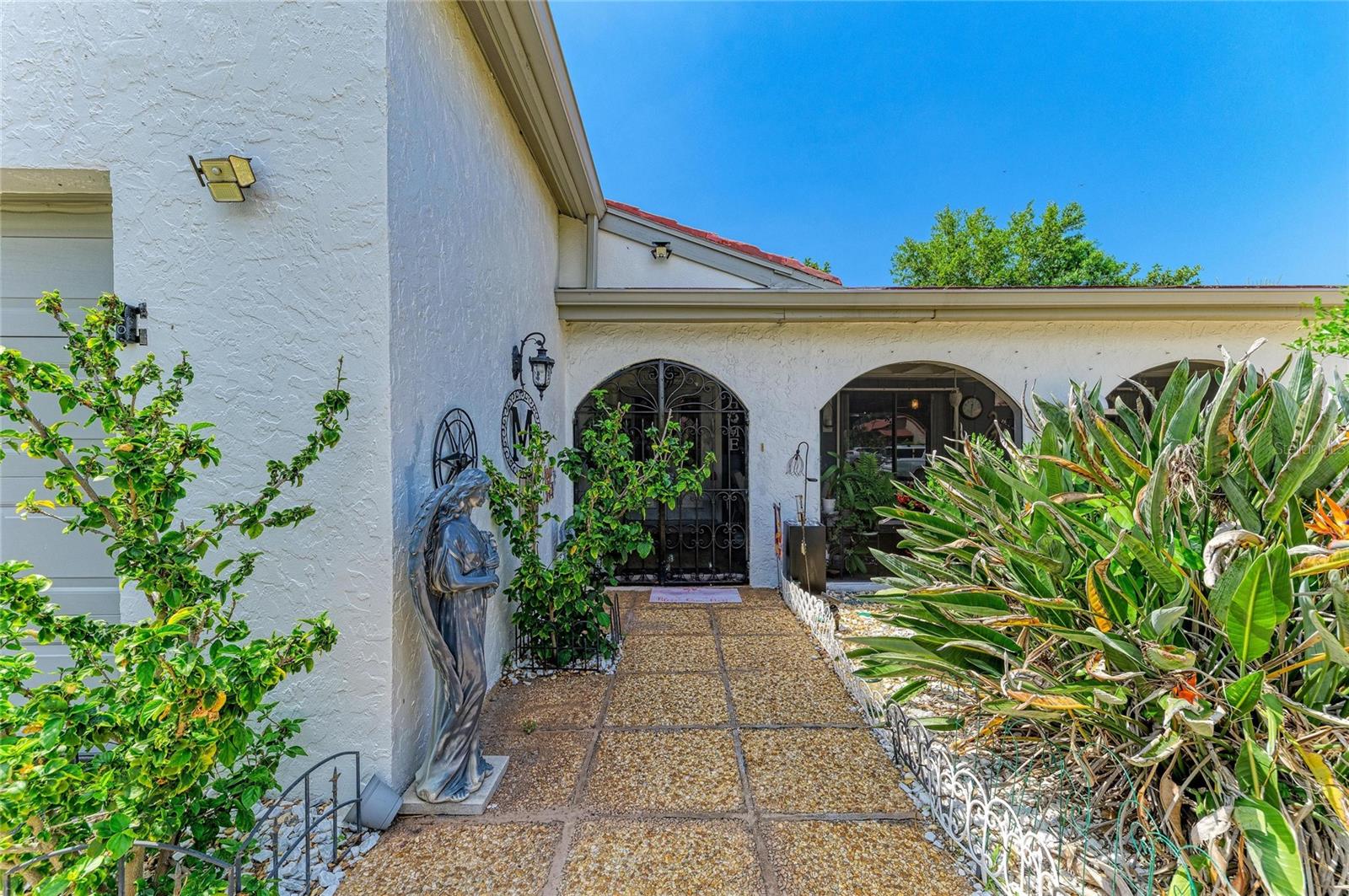 Welcome to 7326 Las Casas Drive, a charming and lovingly maintained villa tucked away at the end of a cul-de-sac in a desirable 55+ community in Sarasota. Perfectly positioned close to the airport, downtown Sarasota, world-famous beaches, shopping, and dining, this home offers both convenience and tranquility. An inviting screened front porch sets the tone as you arrive, providing a relaxing space for morning coffee or evening unwinding. Inside, a spacious living room with double sliding doors and a dry bar creates a comfortable setting for everyday living and entertaining. The large formal dining room is ideal for hosting dinners and gatherings, while the well-designed kitchen offers ample cabinet space and counter space with a pantry to keep everything organized. A versatile bonus room with French doors and new hurricane-impact windows expands your living options, making it perfect as a family room, home office, hobby room, or guest lounge. The large en suite primary bedroom features a stylish barn door leading to the bathroom, which includes a double vanity for added comfort and convenience. Two additional roomy bedrooms provide plenty of space for guests or multi-purpose use; the middle bedroom includes a built-in desk that works well for crafts, computer work, or a quiet work area. Outside, a private backyard with a patio area and garden offers a peaceful retreat for enjoying Florida’s outdoor lifestyle. Lawn maintenance and landscaping are included, and the home is equipped with a sprinkler system, making upkeep easy. The freshly painted interior and exterior create a clean, move-in-ready feel. Located in a friendly 55+ community with a pool and clubhouse, this villa offers an active yet low-maintenance lifestyle in one of Sarasota’s most accessible and desirable locations.
