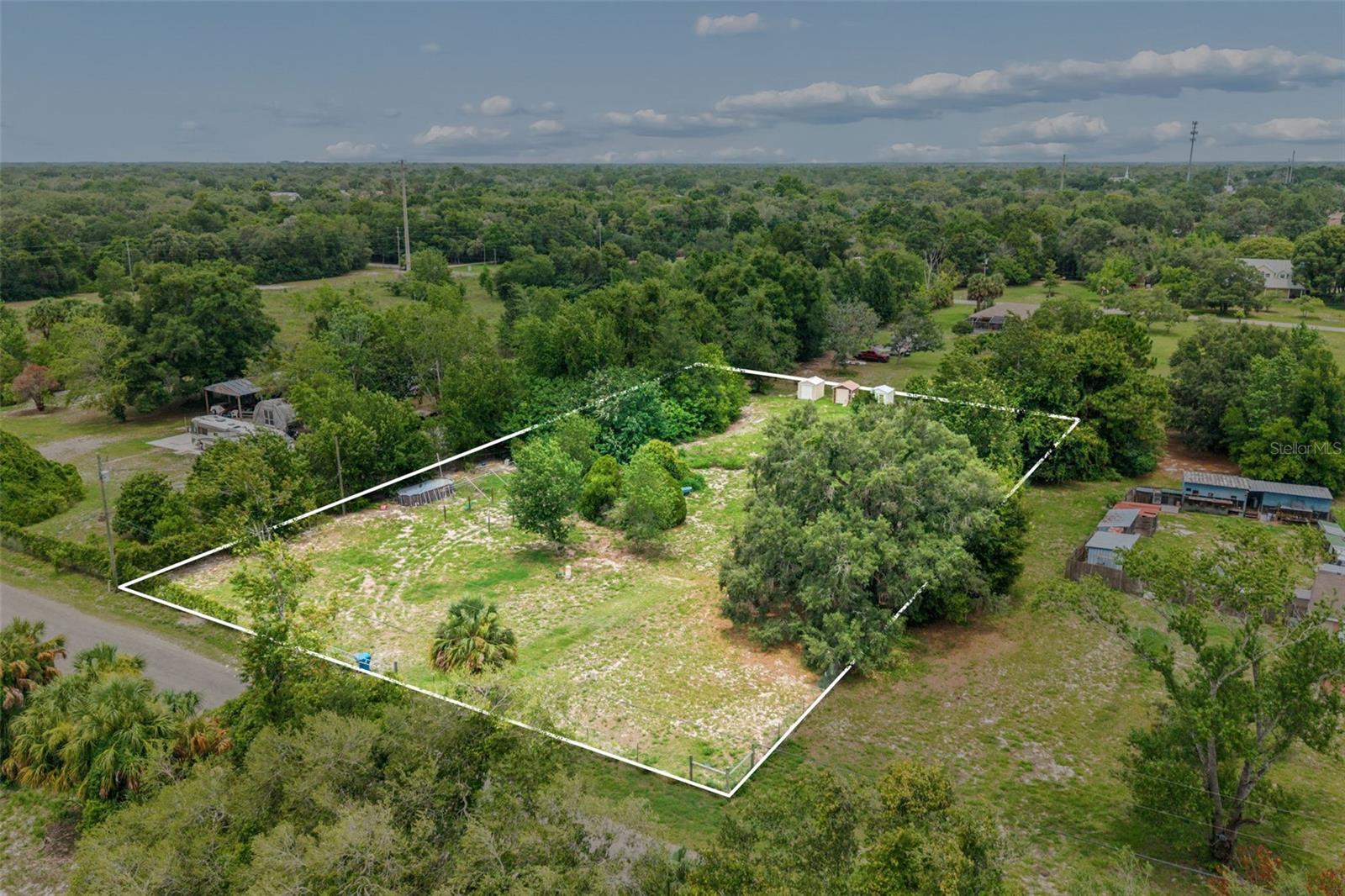Rare opportunity to own a beautiful 1.2-acre homesite in the heart of Spring Hill! This spacious property is already equipped with a well and septic system and is fully fenced, making it an excellent choice for your future home, investment, or recreational use. One of the standout features of this property is the ability to access the lot and create your entrance from either Orchard Way or Christine Way- offering added flexibility for your building plans! Enjoy the privacy and space that acreage provides while still being conveniently located near shopping, dining, schools, medical facilities, and the Suncoast Parkway for an easy commute to Tampa! AR 2 zoning plus no HOA restrictions means plenty of room for your dream home, workshop, RV, boat, or other toys, the possibilities are endless! Don't miss this unique opportunity to own a versatile, ready-to-build parcel in one of Hernando County's fastest-growing areas.