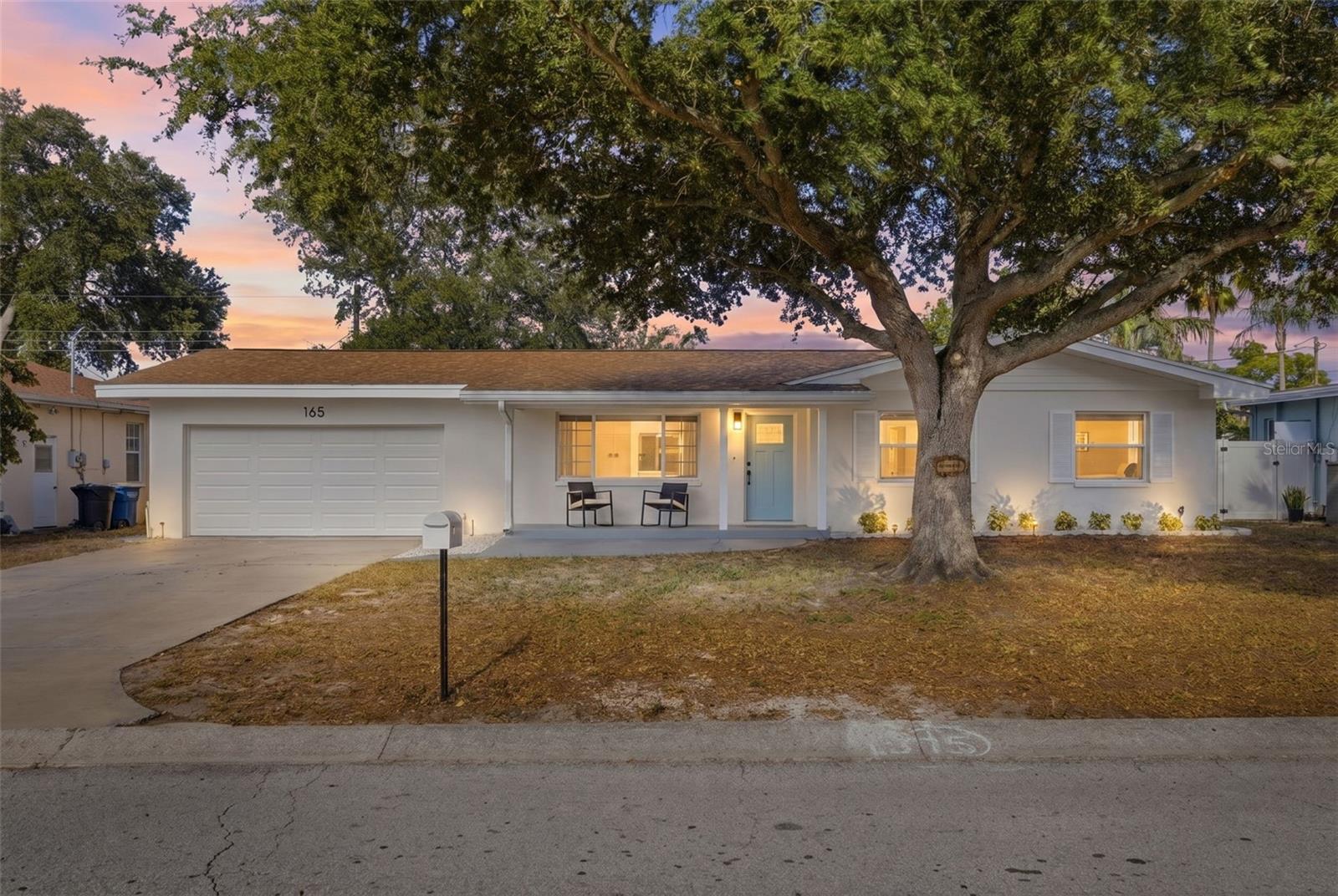 Welcome to this fully renovated 4-bedroom, 2-bathroom home with a 2-car garage, perfectly situated on an oversized lot with no HOA and no flood zone. From the moment you arrive, you'll appreciate the exceptional curb appeal featuring fresh exterior paint, a charming tiled front patio, and an extended driveway offering plenty of parking for family and guests. Inside, the thoughtfully designed open-concept floor plan is filled with natural light and showcases luxury vinyl plank flooring throughout, fresh interior paint, and stylish modern finishes. The beautifully renovated kitchen is the centerpiece of the home, featuring quartz countertops with bar seating, two-tone all-wood soft-close cabinetry, stainless steel appliances, elegant gold hardware, and plenty of space for entertaining. The desirable split-bedroom layout provides privacy for the spacious primary suite, complete with a beautifully updated en-suite bathroom featuring custom tile work and modern finishes. On the opposite side of the home, you'll find three generously sized guest bedrooms along with a fully renovated guest bathroom. Subtle accent walls in both the living room and primary bedroom add warmth and character without overwhelming the space. Enjoy peace of mind knowing the major updates have already been completed, including a 2021 roof, brand-new 2026 HVAC system, new garage door and opener, and newer plumbing and electrical. This truly is a move-in-ready home with nothing left to do. Step outside to the oversized, fully fenced backyard where you'll find a spacious screened-in porch overlooking a yard with plenty of room to add a pool, outdoor kitchen, or create your own backyard oasis. Conveniently located just minutes from BayCare Ballpark, home of Phillies Spring Training, the Joe DiMaggio Sports Complex, Long Center, Ream Wilson Trail, and the Duke Energy Trail. You'll also enjoy easy access to Clearwater Beach, Downtown Clearwater, St. Petersburg, Tampa, St. Pete-Clearwater International Airport, and Tampa International Airport, making both daily commuting and weekend adventures effortless. This is a rare opportunity to own a beautifully renovated, move-in-ready home on an oversized lot in one of Clearwater's most convenient locations.