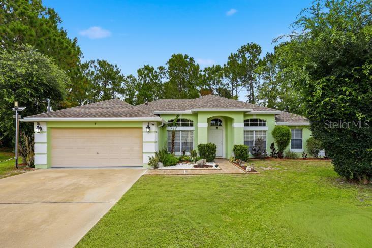 Welcome to this beautifully maintained home located in the desirable Indian Trails section of Palm Coast. Offering 1,800 square feet of living space, this home features 3 bedrooms, 2 full bathrooms, multiple living areas, and an attached 2-car garage, all situated on a private cul-de-sac lot. As you arrive, you'll immediately notice the mature landscaping, large front windows, and welcoming curb appeal. Step inside to the formal living and dining areas, where ceramic tile flooring and abundant natural light create a bright and inviting atmosphere. The centrally located kitchen is designed for both everyday living and entertaining, featuring stainless steel appliances, ample cabinet storage, granite countertops with a waterfall edge, and a breakfast nook overlooking the backyard. The kitchen remains connected to the main living areas, making it easy to stay engaged with family and guests. The primary suite is located on one side of the home, creating a private retreat for homeowners. The spacious bedroom offers two separate closets and an updated ensuite bathroom complete with dual vanities, a soaking tub, and a beautifully updated walk-in shower. Two additional bedrooms and a full guest bathroom are located on the opposite side of the home. Laminate flooring runs throughout the majority of the home, providing durability and easy maintenance. Just off the kitchen, you'll find a convenient indoor laundry room with additional storage space. Through the sliding glass doors just off the living room, you'll find a private backyard designed for both relaxing and entertaining. The covered patio overlooks a pergola and outdoor gathering space, while a storage shed provides additional room for tools, lawn equipment, and seasonal items. With no rear neighbors and a county-owned wooded easement behind the property, you'll enjoy added privacy and a peaceful natural backdrop. Conveniently located near shopping, restaurants, schools, parks, medical facilities, and just a short drive to the beach.