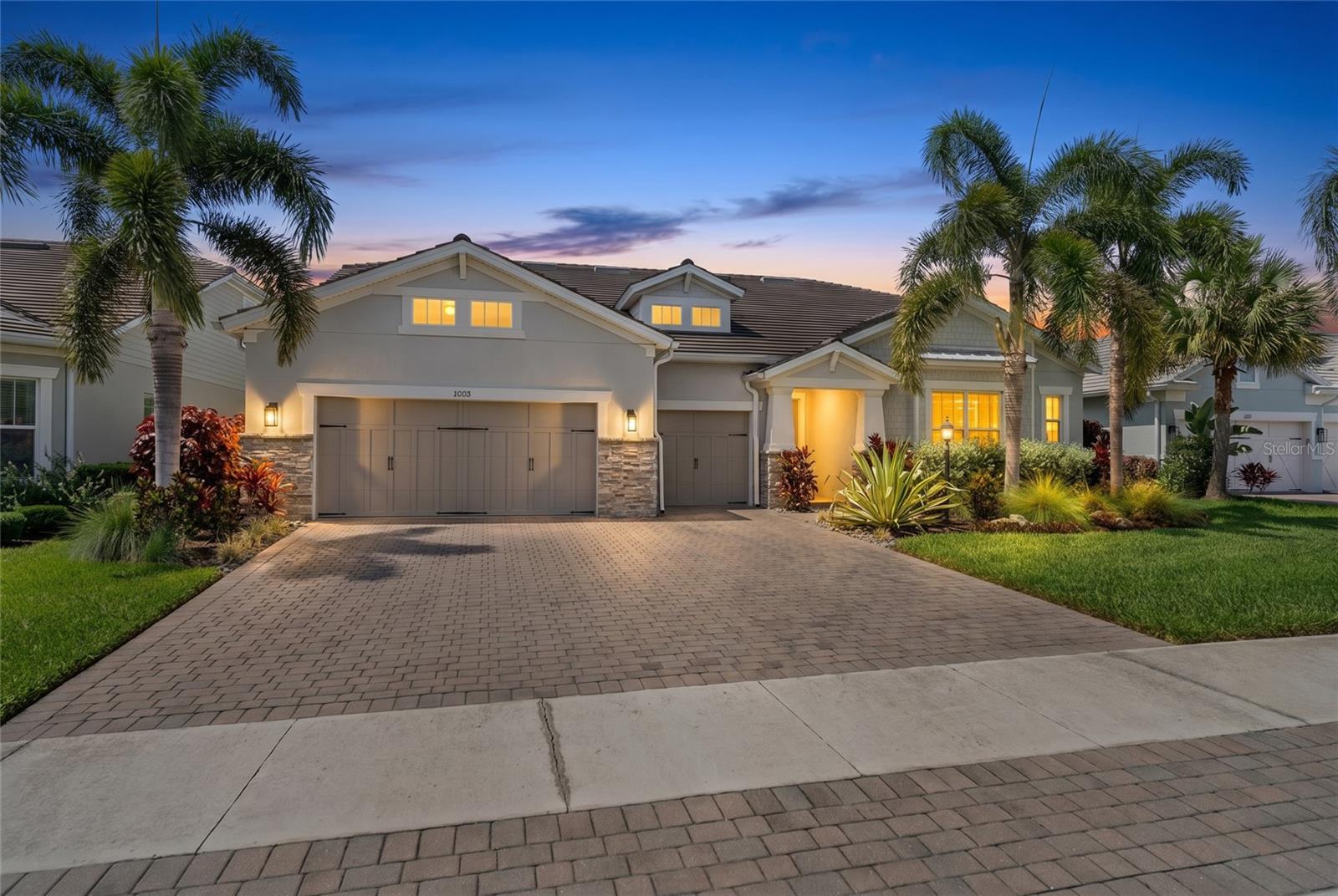 Resort-style luxury meets everyday functionality in one of Mallory Park’s most extensively upgraded homes. Built on the award-winning Nobility floor plan and enhanced far beyond the builder’s offerings, this exceptional residence showcases a level of customization rarely found in Lakewood Ranch. From the moment you enter, you'll appreciate the expansive open-concept design featuring soaring ceilings, decorative wood beam accents, designer lighting, custom cabinetry, automated window treatments, Brilliant Home Panels throughout the home, whole-home automation, a premium multi-zone Sonos audio system serving both the interior and outdoor living spaces, and thoughtfully curated finishes throughout. The chef's kitchen serves as the heart of the home with an oversized island, abundant cabinetry, premium appliances, and seamless flow into the spacious living and dining areas. Custom audio and entertainment systems have also been installed in multiple rooms including the sitting area and primary suite, creating a truly elevated living experience. The luxurious primary retreat offers a spa-inspired bath with an oversized walk-in shower, custom storage, private retreat and generous closet space, while additional bedrooms and flexible living spaces provide room for family, guests, a home office, playroom, or media room. Step outside to your private backyard paradise where an enormous resort-style pool creates a true luxury retreat, featuring a dramatic waterfall wall, three fire features, outdoor kitchen, mosquito misting system, expansive covered lanai, and multiple entertaining spaces designed for year-round Florida living. The oversized garage has been transformed into a versatile fitness and recreation space with durable epoxy flooring and ample room for storage, hobbies, or workouts. Located in the highly sought-after gated community of Mallory Park, residents enjoy resort-style amenities including a community pool, fitness center, clubhouse, pickleball courts, basketball court, playground, scenic walking trails, and golf cart-friendly streets that create a true neighborhood lifestyle. Positioned within the top-rated Lakewood Ranch school district and just minutes from shopping, dining, parks, and everything Lakewood Ranch has to offer, this one-of-a-kind home delivers the perfect blend of luxury, comfort, technology, and convenience.
