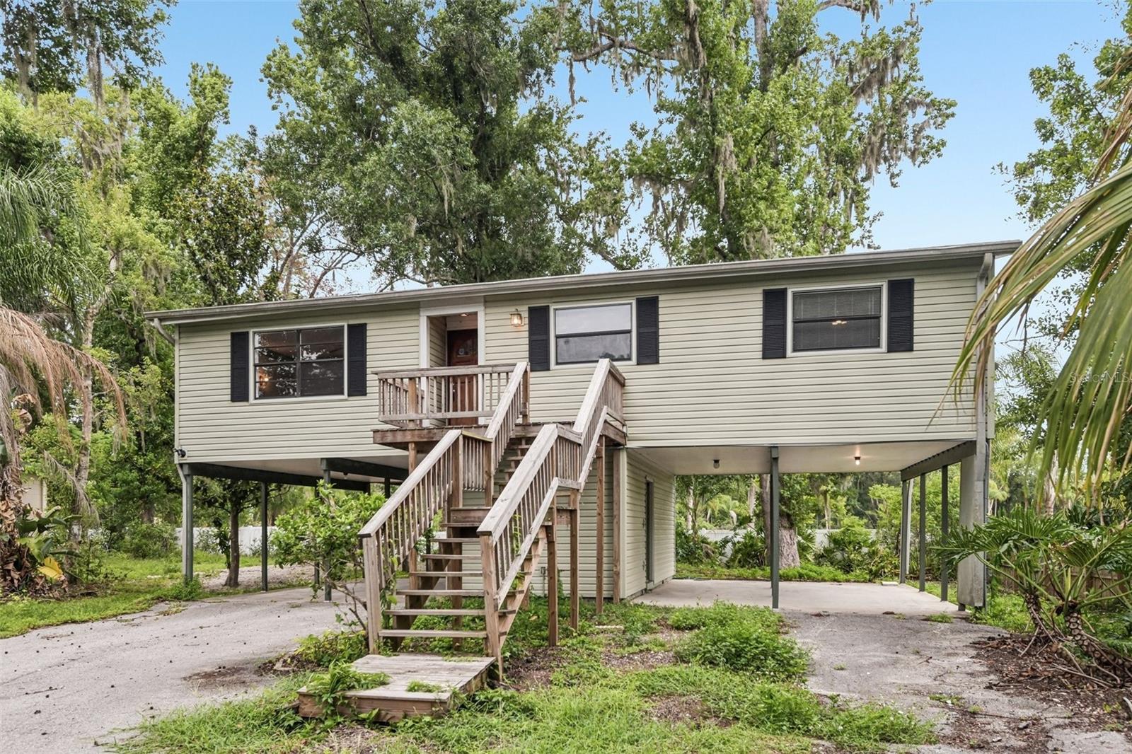 Discover the perfect balance of privacy, practicality, and modern updates at 18411 Autumn Mist Drive in Lutz. Tucked away on a private road, this unique stilt-style residence offers elevated living with added peace of mind, improved drainage, and enhanced airflow—an ideal design for Florida's climate. This 3-bedroom, 2.5-bath home features a spacious main living area on the upper level, while the lower level provides exceptional versatility with a convenient half bath, laundry area, and two large storage rooms perfect for hobbies, equipment, or additional organizational space. The covered parking area beneath the home includes two carports with room for up to four vehicles, boats, trailers, or recreational toys. Recent improvements make this home truly move-in ready, including a brand-new roof installed in 2025, new septic drain field in 2026 and an HVAC system replaced in 2022. Additional updates throughout the property enhance both comfort and functionality, allowing the next owner to enjoy the home with confidence. The private road setting creates a quiet, low-traffic environment while still offering easy access to shopping, dining, parks, nature preserves, local waterways, top-rated schools, and major commuter routes. Combining distinctive architecture, valuable updates, abundant storage, and a sought-after location, this property presents a rare opportunity to enjoy a peaceful lifestyle without sacrificing convenience. Schedule your private showing today.