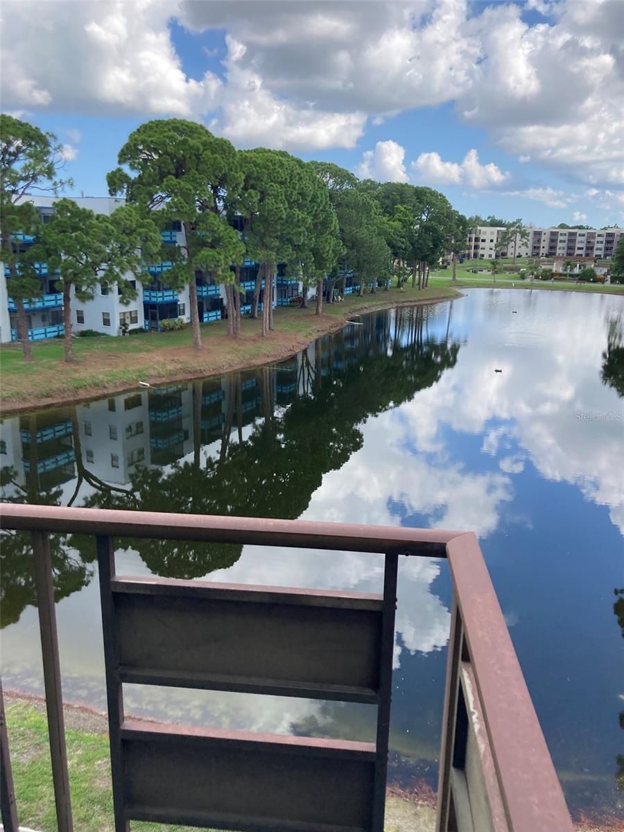 Investor Special!  Top floor waterfront 2 bedroom in the Jefferson Building at Five Towns, the premier 55+ condominium community for active seniors.  This unit has been foreclosed and is bank owned. It has been prepped for rehab, so come take a look.  No carpet, just concrete in most areas.  Great floor plan with a connected washer/dryer combo in the kitchen.  The balcony (not screened) overlooks a beautiful pond. The stove, dishwasher and fridge remain.  One bathroom will need a shower installed.  Some updates have been completed.  Come take a look!  This might be your forever home or a fabulous investment to flip or hold for rental.  The Five Towns community offers multiple swimming pools, two clubhouses, a monthly newsletter to keep informed of all the groups and activities you may want to try!  Tennis, pickleball, bocce ball and shuffle board.  Two fully equipped gyms, card rooms, billiard room, and auditoriums.  Ideal location in St Petersburg with resturants, shopping, a short drive to the beach and the interstate.  One covered parking space is included.