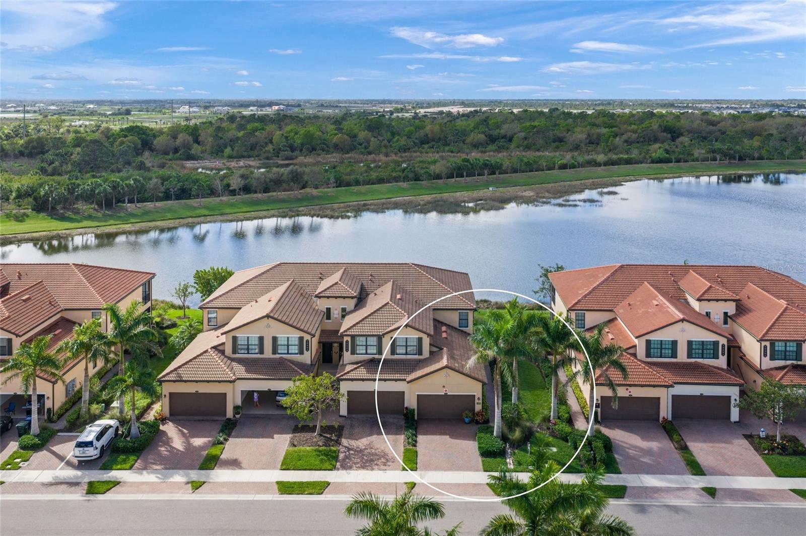 A must see at this price!  Please enjoy viewing this beautifully upgraded first floor end unit condo with a stunning water view. 3 bedrooms, 2 bathrooms and a 2 car attached garage.  Two golf memberships are included with this home in the Sarasota National gated golf community with resort style amenities, along with acres of bird sanctuaries and preserves.  The water view from the lanai and rear interior is spectacular for entertaining friends or for your own quiet enjoyment.  The home's covered and screened lanai has three electric “Hurricane Screens" for extra storm protection and Panorama Screens customized to avoid those pesty "no-see-ums".  The home interior boasts a leaded glass entryway door, upgraded tile floors in the common areas, wood kitchen cabinetry, quartz countertops for the kitchen counters and center island, decorative pendant lighting, with a subway tile backsplash and beautiful stainless appliances.  The condo's impact glass, extra lighting, spacious great room  with wood herringbone accent wall, and dining room all provide for a light and bright interior space.  The primary bedroom is generous in size, with “walk-in” closet, double vanities and a "walk-in" shower.  There are 2 additional bedrooms for guests/family or for using one as a "home office".  The garage floor has an "epoxy" type coating and the Sellers applied sealant to the driveway and sidewalk pavers.  Exterior maintenance is included along with water, sewer and cable.  Sarasota National features a premier 18 hole golf course undergoing a major renovation, clubhouse, restaurant, community pool and spa, poolside "Tiki-Bar", Fitness center, day spa, playground, Pickleball courts, Tennis courts, Bocci Ball courts, coffee lounge, library, dog park, and plenty of trails.  All this is in proximity to area parks, downtown Venice, Braves Baseball Spring Training, golf courses, Gulf beaches, Retail and Dining.