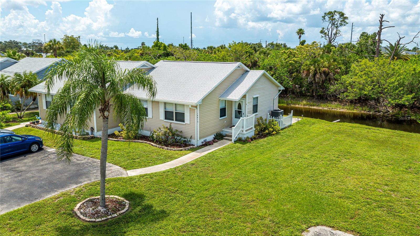 MUST SEE MOVE IN READY HOME UNDER 150K. Welcome to easy Florida living in the sought-after Waterway Village, a tranquil community where comfort, convenience, and waterfront serenity come together. Perfectly positioned on a PEACEFUL CANAL without backyard neighbors, this beautifully maintained home offers an open, airy layout, vaulted ceilings, abundant natural light, and an OVERSIZED screened lanai where you can relax with your morning coffee while enjoying tranquil water views. The chef worthy kitchen features deluxe granite countertops, brand new shaker cabinetry, stainless steel appliances, convenient breakfast bar, and plenty of workspace, all overlooking the main living area perfect for entertaining family and friends. This special 2/1  boasts an open floor plan providing privacy for both owners and guests, with generously sized bedrooms and a wonderfully updated bathroom offering a bright, clean, move-in-ready feel. Step outside to your huge screened lanai from two sets of sliders from the kitchen or living room and enjoy peaceful canal views, tropical landscaping, Florida nature and a spacious backyard with room to garden or simply unwind. Residents of Waterway Village enjoy a beautifully maintained community pool, clubhouse, park with picnic table, walking paths, and a welcoming neighborhood atmosphere, all just minutes from shopping, dining, golf courses, medical facilities, and the beautiful Gulf beaches with low $186 month HOA that includes lawn maintenance also! HIGHLIGHTS INCLUDE: NEW ROOF 2022, NEW INSULATION 2023, CLOSED CELL FOAM UNDER TREATMENT, NEW AIR CONDITIONER 2024, INSIDE LAUNDRY, CITY WATER, CITY SEWER, plus CAN BE SOLD TURNKEY FURNISHED. Whether you're searching for a year-round residence, winter retreat, investment opportunity or low-maintenance Florida lifestyle, this exceptional villa offers the perfect combination of modern updates, peaceful waterfront surroundings, and an unbeatable location. SCHEDULE YOUR PRIVATE SHOWING TODAY and discover why Waterway Village  perfectly located between North Port, Englewood and Port Charlotte is one of the areas most incredible hidden gems!