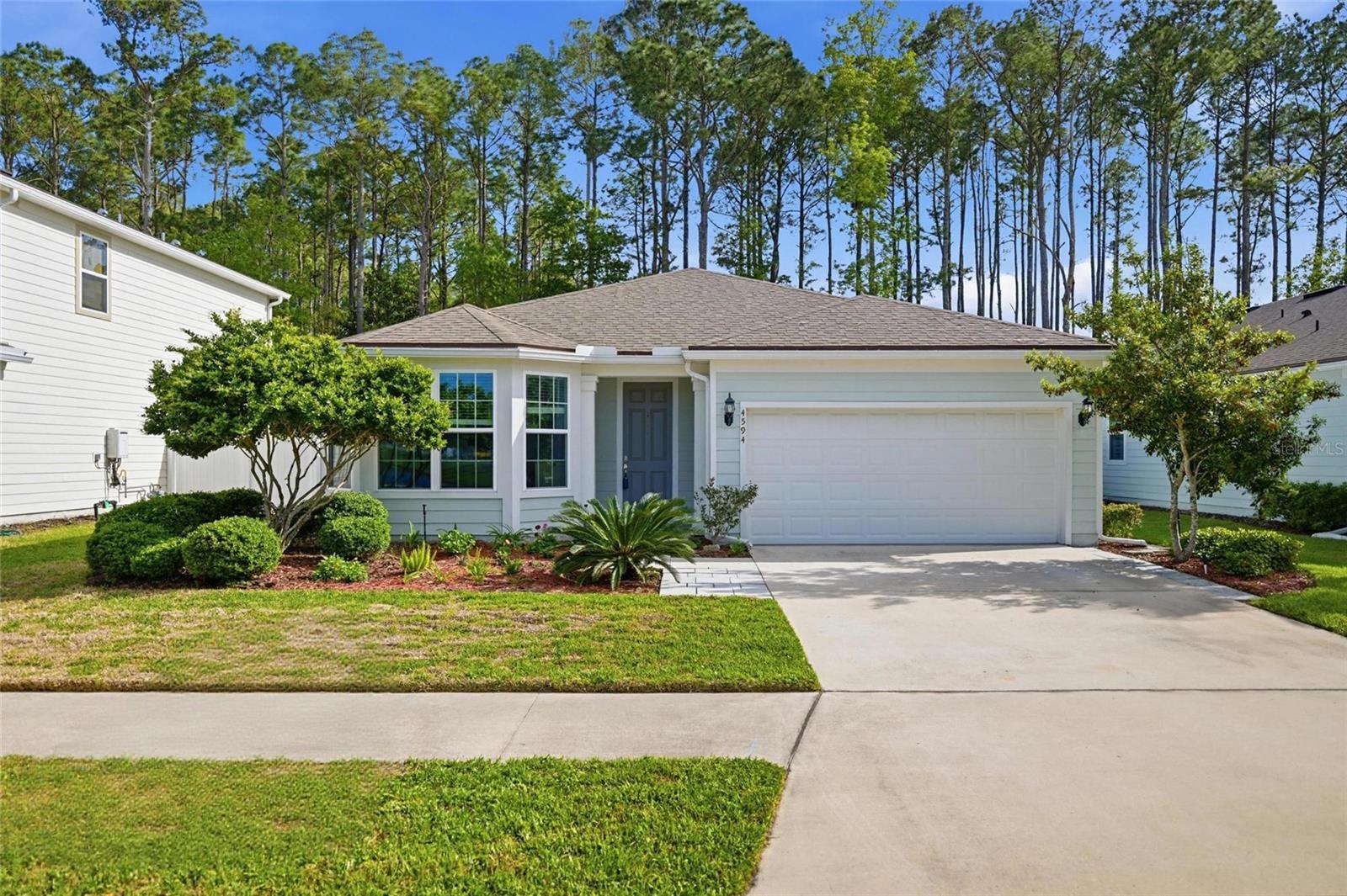 Seller will contribute $9,000 toward the buyer’s closing costs with an acceptable offer. Looking to relocate to Northeast Florida. Welcome to this beautifully designed home in the highly sought-after Bradley Pond community--where scenic water views, wooded preserves, and everyday convenience come together. Designed with both style and functionality in mind, this award-winning floor plan offers a bright, open-concept layout with 3 spacious bedrooms, 2 full bathrooms, and a versatile flex room perfectly positioned to capture tranquil water views--ideal for a home office, playroom, or additional living space. Soaring 9-foot ceilings and thoughtfully selected finishes create an inviting, modern feel throughout. At the heart of the home, the chef-inspired kitchen is built for both entertaining and daily living, featuring quartz countertops, an oversized island with pendant lighting, 42'' cabinetry with soft-close doors and double roll-out drawers, stainless steel appliances, a large pantry and the added benefit of natural gas. The spacious great room flows seamlessly to an enclosed lanai through triple sliding glass doors, extending your living space outdoors. Enjoy peaceful mornings or evening gatherings while overlooking a private backyard with a unique combination of white vinyl and aluminum fencing--perfectly framing serene forest views. The primary suite offers a relaxing retreat with a large walk-in closet, dual vanities, a garden tub, and a separate shower. Additional upgrades include a finished 2-car garage and leaf-filter gutter guards for added convenience and low maintenance. Beyond the home, Bradley Pond offers a lifestyle that's hard to match--featuring five scenic ponds, a playground, walking and hiking trails, and a kayak launch into Clapboard Creek for outdoor enthusiasts. This is more than just a home--it's a lifestyle defined by comfort, nature, and thoughtful design.