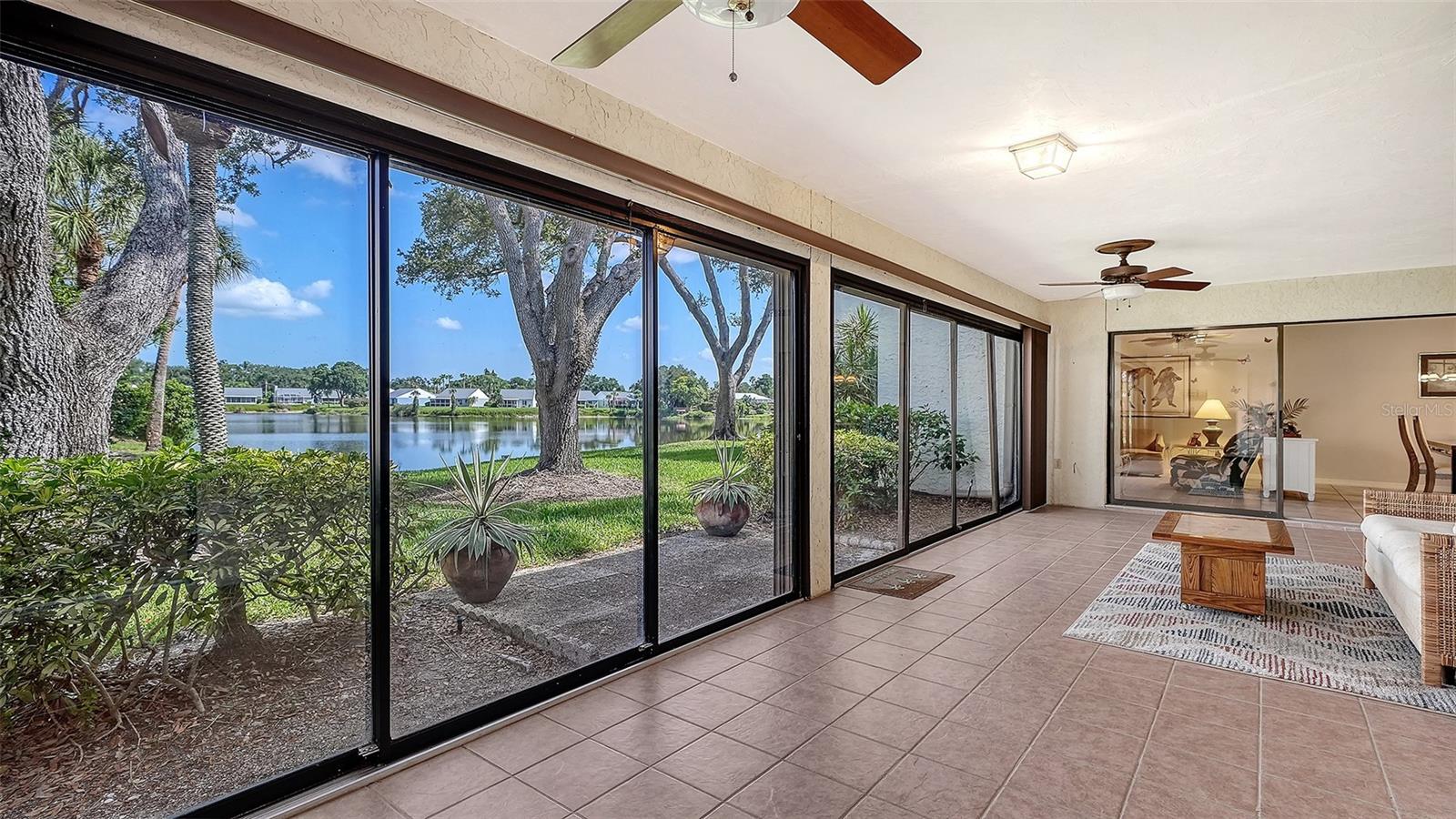 **Rarely available** single-level, 3-bedroom, 2-bath condominium with **no unit above**, spectacular lake views, and an impressive **32-foot glass-enclosed lanai** overlooking a picturesque 10-acre lake. Located in **one of West Bradenton's most distinctive residential communities**, this spacious home offers **1,818 square feet of air-conditioned living space** and nearly **2,300 square feet under roof**.

The open floor plan is designed for both comfortable everyday living and entertaining. A spacious kitchen with breakfast bar overlooks the living and dining areas, while the living room flows seamlessly into the third bedroom—currently used as a den—and the expansive lanai, creating bright, flexible living spaces that take full advantage of the beautiful lake views.

Both bedrooms feature walk-in closets and sliding glass doors opening to a private, secure courtyard—an ideal space for morning coffee, a small garden, quiet reading, or convenient bicycle storage. Two covered parking spaces are located directly across from the home for added convenience.

Wildewood Springs/Spring Lakes is one of West Bradenton's most distinctive residential communities, encompassing approximately 100 acres with more than 900 residences. Unlike many condominium communities, it is defined by mature oak trees, scenic lakes, winding roads, and abundant green space, creating a peaceful setting that feels more like a private nature preserve than a typical condominium neighborhood.

Residents of this association enjoy access to **two heated pool and spa areas**, along with **tennis and pickleball courts**. The association is professionally managed, with **no special assessments currently due or pending**.

Conveniently located just off Cortez Road, you'll be minutes from grocery stores, restaurants, movie theaters, and four public or semi-private golf courses within approximately three miles. The beautiful Gulf beaches of Holmes Beach are only about **6.5 miles away**, placing some of Florida's finest beaches just a short drive from your doorstep.

Whether you're searching for a full-time residence or the perfect seasonal retreat, this home offers an exceptional combination of spacious single-level living, breathtaking lake views, maintenance-free convenience, and an outstanding West Bradenton location.