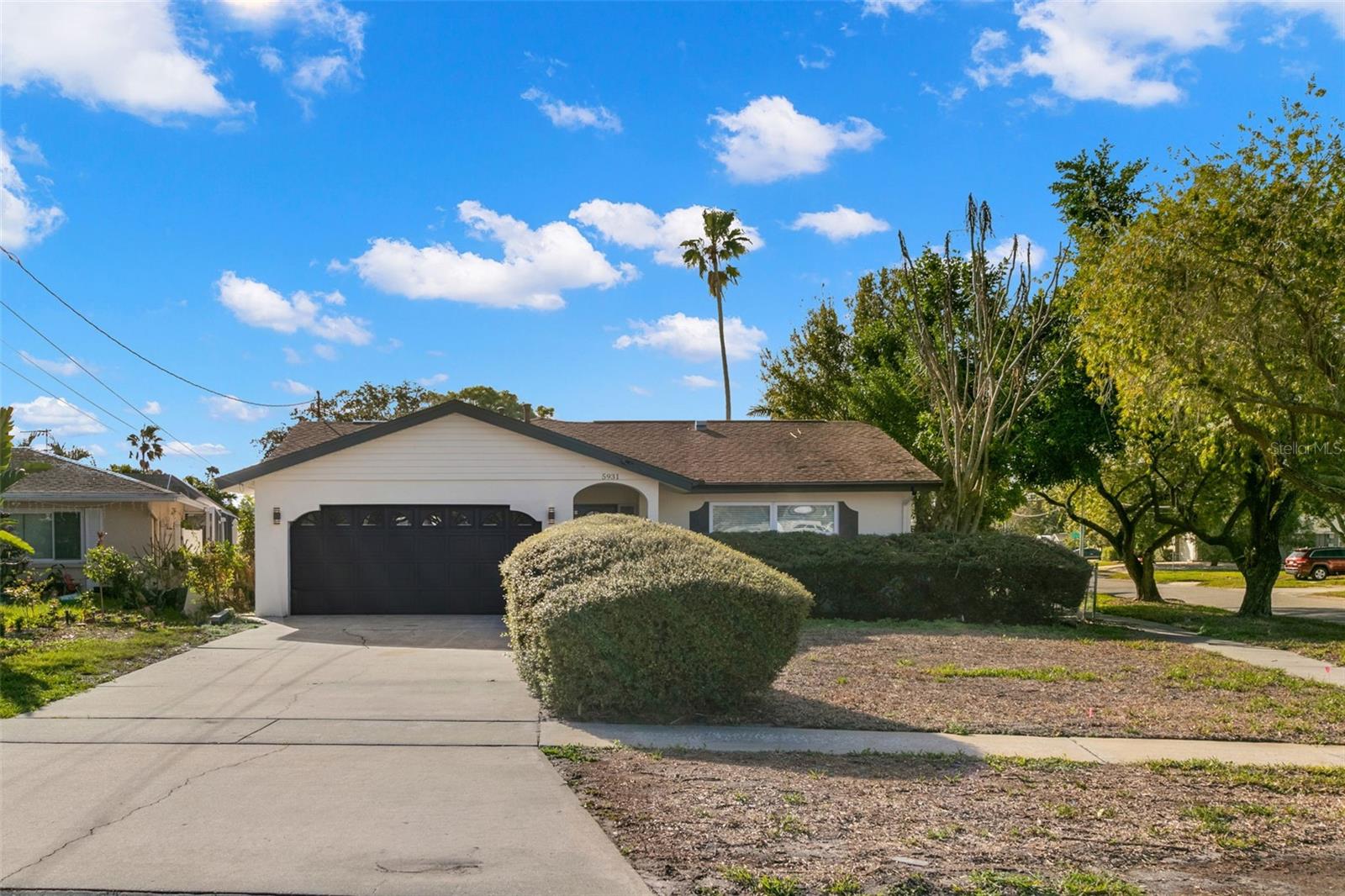 Nestled in the highly desirable Shore Acres neighborhood of Northeast St. Petersburg, this beautifully established community offers the perfect blend of peaceful residential living and everyday convenience. Just minutes from the sparkling waters of Tampa Bay, residents enjoy easy access to waterfront parks, walking and biking trails, fishing piers, boat ramps, playgrounds, and endless opportunities to embrace the Florida lifestyle. Situated on a desirable corner lot with sidewalks, this beautifully remodeled four-bedroom, two-bathroom home with a two-car garage has been thoughtfully redesigned from top to bottom, offering the perfect combination of modern style, comfort, and functionality. Every detail has been carefully updated, creating a move-in-ready home that feels brand new from the moment you arrive. Luxury vinyl plank flooring flows throughout the home, complemented by high-impact windows that provide both peace of mind and energy efficiency. The thoughtfully designed floor plan offers seamless flow between the living room, dining area, and kitchen, creating an inviting space that's perfect for both everyday living and entertaining. The stunning chef-inspired kitchen serves as the centerpiece of the home, showcasing beautiful quartz countertops, a dramatic waterfall island with bar seating, modern cabinetry, and brand-new stainless steel appliances. Just beyond, the spacious family room creates the ideal gathering space for family and friends. The private owner's suite offers a relaxing retreat featuring a beautifully renovated ensuite bathroom complete with a quartz-topped vanity and an elegant floor-to-ceiling tiled walk-in shower. Three additional generously sized bedrooms provide flexibility for family, guests, or a home office, while the fully remodeled guest bathroom continues the home's modern finishes and timeless design. Step outside to the covered lanai, where you'll have the perfect space for outdoor dining, weekend barbecues, or simply relaxing year-round while overlooking the expansive backyard. With plenty of room for pets, play, gardening, or even a future pool, the outdoor space offers endless possibilities to create your own private Florida oasis. This sought-after area is known for its mature tree-lined streets, welcoming neighborhood atmosphere, and close proximity to vibrant Downtown St. Petersburg, where you'll find award-winning restaurants, waterfront dining, boutique shopping, museums, live entertainment, and year-round festivals. Outdoor enthusiasts will appreciate being just minutes from Weedon Island Preserve, Mangrove Bay Golf Course, Cypress Links Golf Course, and numerous parks, while everyday conveniences including Whole Foods, Publix, Trader Joe's, Fresh Market, Target, shopping centers, medical facilities, and countless dining options are all nearby. With quick access to I-275, the Howard Frankland Bridge, Tampa International Airport, and the Gulf Coast's world-famous beaches, this location truly places everything at your fingertips. Schedule your showing today!