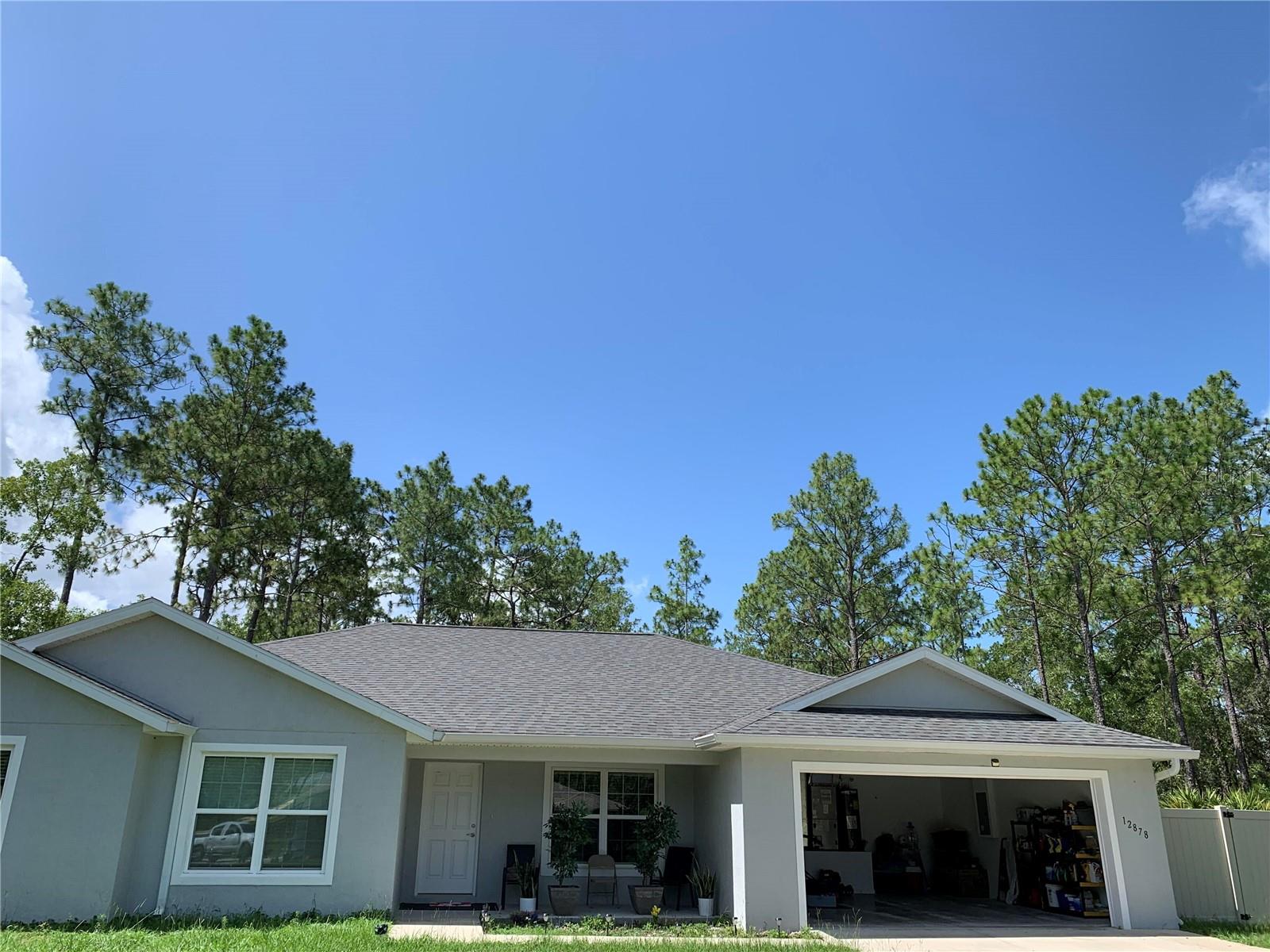 Discover the charm of this delightful retreat with its welcoming exterior and appealing architectural design. Home warranty included. Enjoy nature in your backyard while sipping your coffee and spectacular views on your screened porch with over an acre of land to build another home, pool, store your toys like a boat, golf cart, and/or have farm animals. This open layout includes a large entryway leading to over 1900 sq footage of space with a separate dining area, laundry room with included washer with warranty and dryer. Already wired for internet, and T.V. This includes multiple bedrooms that you could turn into your private office, a comfortable living area, and has a granite countertop island in the kitchen. A peaceful retreat while being conveniently located near local attractions like rainbow springs park and outdoor recreation like the world famous equestrian center. Has built in privacy fence, gutters, and water filtration and softener system with UV light,  NO HOA OR CDD TO WORRY ABOUT and quiet neighborhood that provides amenities such as pickleball, tennis, basketball, racquetball, picnic area and lake with playground area. What are you waiting for? Come see it!