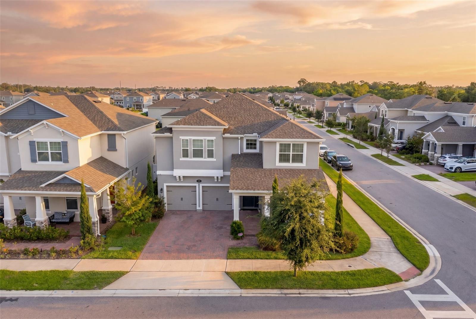 More Home. More Finish. Multi Generational.

Some homes in a community stand out from the rest. 700 Albyon Ct is one of them. Sitting inside Rivington, one of Debary's most sought-after master-planned communities, this MI Homes-built residence offers 3,689 square feet of thoughtfully upgraded living space, one of the largest floor plans in the neighborhood, and the kind of finish level that most new construction buyers pay extra to add after closing.

This 5-bedroom, 5 full bath home was built with extras from the start and it shows at every turn.
The main living level sets the tone immediately. Wood-look tile flooring runs throughout the downstairs, clean and durable, anchoring an open layout that connects the family room, dining area, and kitchen without a single wasted step. The kitchen is the focal point of the first floor, featuring shaker cabinetry, a striking navy blue quartz island, stainless steel appliances, a gold-accented farmhouse faucet, and pendant lighting that earns its place. A dedicated butler's pantry gives you the additional prep and storage space that busy households actually need.

Two primary suites set this floor plan apart from anything else in the community. Whether you are accommodating multi-generational living, a long-term guest, or simply want the flexibility that a second full primary provides, this home was designed for it. The main primary suite upstairs is generous in size, with LVP flooring that runs throughout the second floor, a frameless glass shower with designer tile, upgraded fixtures, and a walk-in closet with built-in organization.

The secondary bathroom downstairs mirrors the same elevated finish level, with Carrara marble-look tile, dual arched dark-framed mirrors, a soaking tub, and a separate frameless shower, the kind of bath that photographs like a boutique hotel and functions just as well.
Upstairs, the home theater loft is a true bonus space, wired and ready with a ceiling-mounted projector, a full-size projection screen, and room for the entire family to settle in. Down the hall, a dedicated built-in home office with dual workstations and floor-to-ceiling shelving eliminates the need to convert a bedroom. It was designed as a workspace from the start.

Outside your front door, Rivington delivers resort-style amenities that match the home's interior quality. A lakefront community pool, a modern clubhouse, a playground, and walking paths along the water give the neighborhood a lifestyle that the address alone cannot fully describe.

Located in Debary with quick access to US-17, I-4, and the SunRail station, this home connects you to Orlando, Lake Mary, Sanford, and the coast without making you feel like you live in the middle of any of them.
