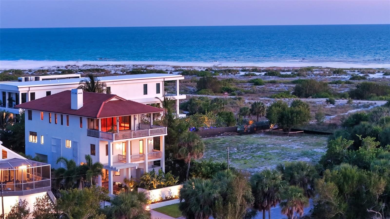 Wake up to the sound of waves and fall asleep to Gulf breezes in this extraordinary three-story residence, perfectly positioned just steps from the white sands of Lido Beach. With direct access to the nature trails along Pansy Bayou and sweeping views of the water, sunsets, and the tranquil shores beyond, this is not simply a home, it is a lifestyle.
Custom-built in 2003 by the current owner and meticulously maintained ever since, this 4,486 sq. ft. masterpiece was constructed for the long term. Masonry materials, a piling foundation, and fortress-quality construction have protected this home through every season, with no history of storm damage or water intrusion, offering exceptional peace of mind.
Inside, every detail reflects thoughtful craftsmanship. Rich solid wood floors and staircases flow throughout, complemented by soaring ceilings and walls of windows that flood the home with natural light. A private elevator connects all three levels with ease. The layout is designed with both privacy and elegance in mind, featuring a serene master retreat on the second level, dedicated guest accommodations, and a stunning artist's studio outfitted with generous storage and bathed in light.
The upper living level is the crown jewel, an entertainer's dream open to sky, water, and nature. The chef's kitchen impresses with thoughtful design and a generous walk-in pantry, while the showstopping terrace delivers breathtaking panoramic views that must be seen to be believed.
Tucked at the end of a quiet private drive, the home offers rare seclusion without sacrifice. St. Armands Circle's world-class dining and upscale shopping are just a leisurely stroll away. An oversized attached garage plus additional off-street parking complete this exceptional offering.
Homes of this caliber, in this location, simply do not come available often.