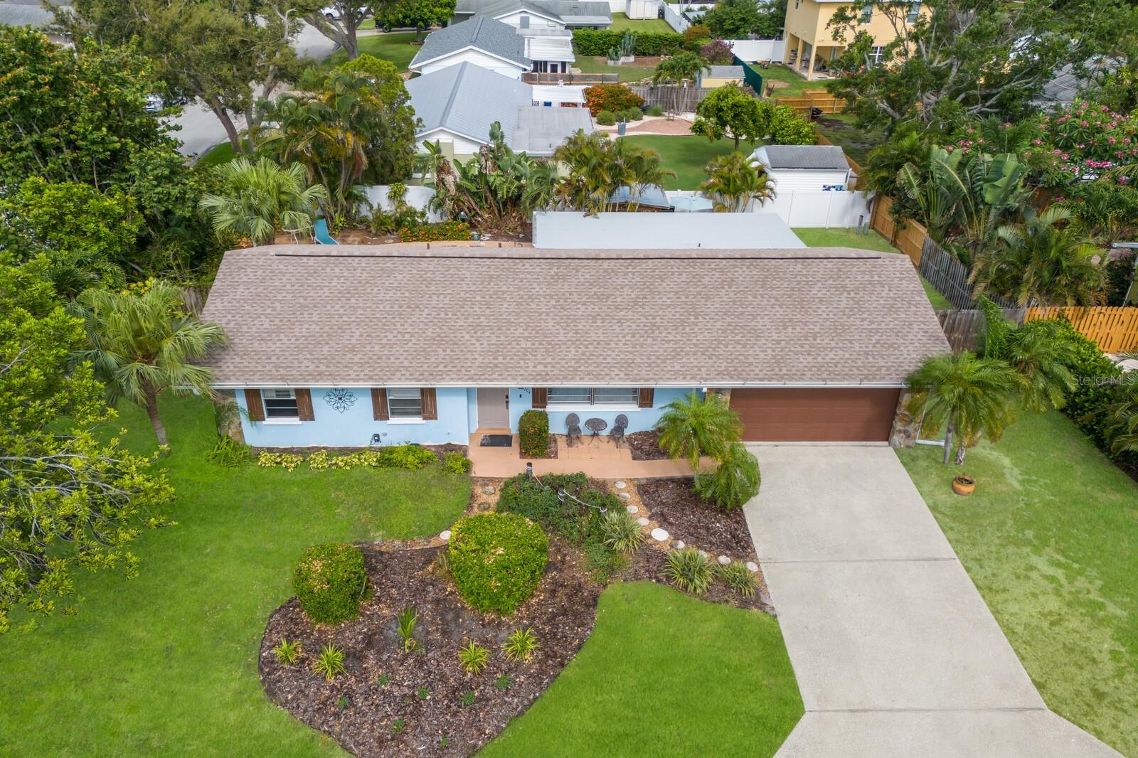 A tropical oasis in Northwest Bradenton, just around the corner from famous Anna Maria Island, Holmes Beach and only 2.5 miles to the sandy shores of dog-friendly Palma Sola Causeway! Welcome to Serenity by the Sea, an active and successful three-bedroom, two-bath, 1,532-square-foot short-term rental property. Between the beautiful upgrades both inside and out and the perfect location, it's no wonder this home has been generating substantial rental income since 2021! The owners have recently completed several large upgrades to the property for peace of mind as well as long-term value. Some notable improvements include brand new luxury vinyl flooring throughout the entire interior(2026) a new roof (2024), a new HVAC (2024), a new electrical panel (2025), new pool heater and pump (2024), newly installed irrigation system (2025), addition of gutters around entire home (2024) and a new vinyl privacy fence (2024). No need to worry about resurfacing the pool either, as it has already been resurfaced with Pebble Tech! 
Upon entering the home, you're greeted with a bright, coastal-inspired interior, professionally furnished and styled to create a relaxing, vacation-ready atmosphere. Down the hallway is a well-appointed large storage closet, hidden by two stylish sliding barn doors just before arriving at the guest bathroom which features new vinyl flooring and a large shower/tub combination. At the end of the hallway are two nicely sized bedrooms positioned on the opposite side of the primary suite. The primary bedroom has a peaceful view directly overlooking the pool and lush landscaping outside, as well as a beautifully updated coastal-inspired en-suite bathroom. Through the kitchen and oversized Florida room, the perfect piece of tropical paradise awaits you. The backyard is truly a serene private Florida oasis, featuring beautiful towering palm trees and lush landscaping, a resort-style heated swimming pool with several lounge chairs, a dining area, and even your own private outdoor shower! Adding to the appeal of the outdoor living space is not only an additional fenced-in yard, but also a large custom-built, concreate-reinforced, bamboo tiki bar! The ideal place to get together with friends or family to have some refreshing drinks while enjoying some sun or even a beautiful famous Florida sunset right from your backyard.
Just minutes from some of Florida's best beaches, shopping, waterfront dining, beachfront horseback riding, historical downtown Bradenton and several world-class hospitals, this home has it all.
With no HOA or deed restrictions and the option to purchase this home turnkey furnished or unfurnished, jump on this opportunity for the flexibility to continue operating as a thriving vacation rental or to call this beautiful property, home!