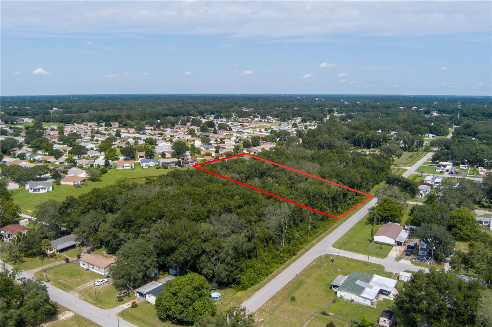 OWNER FINANCING AVAILABLE - LARGE LOT RE ZONING MINUTES TO THE VILLAGES!  Discover the perfect setting for your dream home on this beautiful 1.88-acre parcel with RE (Residential Estate) zoning. Ideally located just off Hwy. 441 and Hwy. 42, this property offers the perfect blend of privacy and convenience. Enjoy a peaceful setting with no neighbors directly behind you, providing added privacy and a serene backdrop for your future home. The paved road frontage provides easy access, while the generous acreage gives you plenty of space for a custom estate, workshop, garden, or outdoor living area. Situated near Lake Weir and just minutes from The Villages, you’ll have quick access to shopping, dining, entertainment, and recreation while still enjoying the quiet feel of country living. Whether you’re ready to build now or invest for the future, this property offers location, space, and privacy all in one exceptional opportunity.