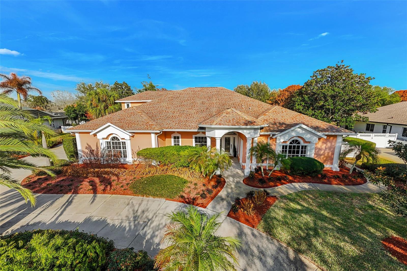 Set on a private ½-acre estate between the rivers in South Merritt Island, this light-filled coastal residence offers refined luxury living designed for entertaining & elegance. Arrive via a sweeping circular drive & step into open spaces enhanced by stunning 3' x 3' polished porcelain tile. Featuring 5 bedrooms, 3.5 baths, & spacious upstairs flex room ideal as a 6th bedroom, executive office, or media room. The private primary wing includes an adjoining flex space perfect for a nursery, dressing room, or study. The showstopping chef's kitchen is the heart of the home, appointed with SS appliances, double ovens, double sinks, a professional-grade cooktop, an impressive 9-ft island, quartz tops, custom backsplash, a Butler's pantry, and maple cabinetry. Outdoor living shines with an oversized screened lanai, summer kitchen, solar-heated pool, outdoor shower, fenced yard & lush fruit trees. Oversized garage, newer roof, & updated systems complete this exceptional offering.