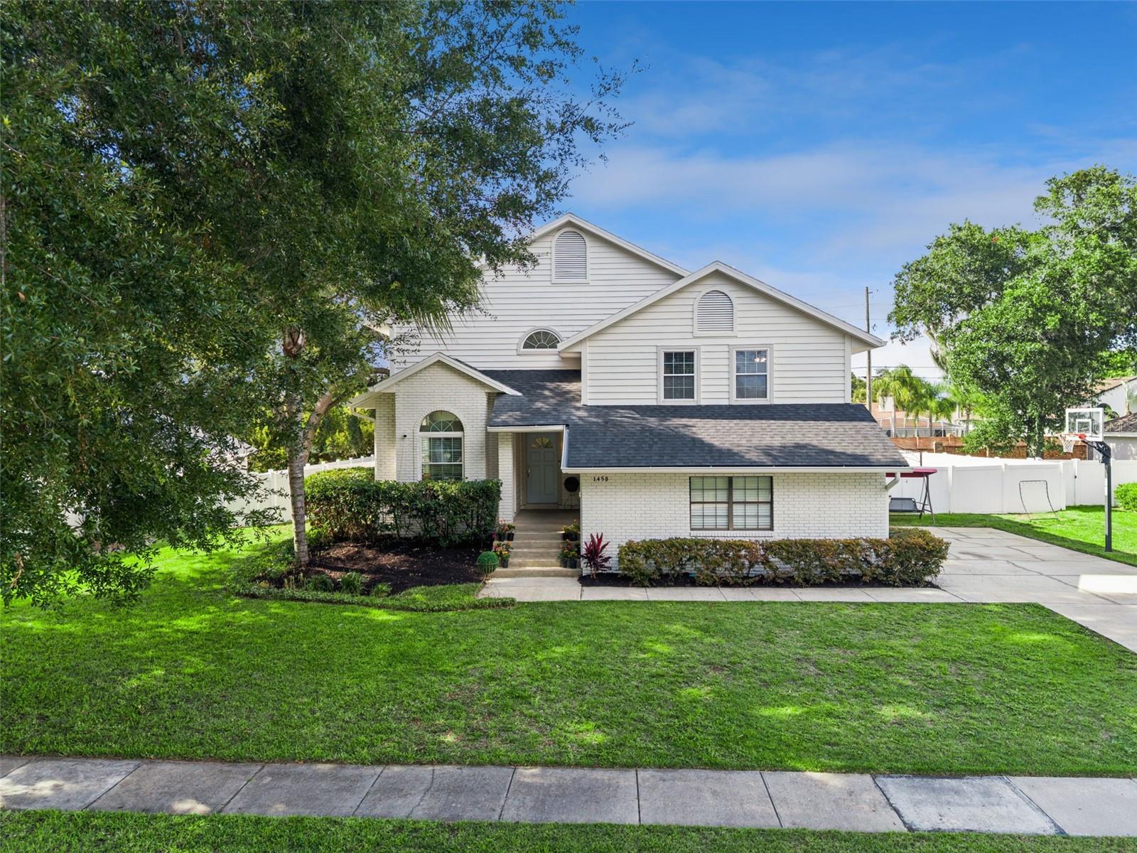 Welcome to Royal Estates, one of Apopka's most desirable established communities, ideally located just moments from beautiful Bear Lake and zoned for highly sought-after Lake Brantley schools. This beautifully refreshed 4-bedroom, 2.5-bath home offers 2,273 square feet of comfortable living space, exceptional curb appeal, and a spacious, fully fenced backyard that's perfect for entertaining, pets, play, or simply enjoying your own private outdoor retreat.  PLENTY of room for a pool, if desired! 
From the moment you arrive, you'll appreciate the home's impressive updates, including a BRAND-NEW ROOF (2026) , freshly painted exterior (2026) in an in-trend designer color palette, and professionally refreshed landscaping that creates a polished, move-in-ready first impression.
Inside, soaring vaulted ceilings and abundant natural light enhance the home's inviting multi-level floorplan. The fabulous open kitchen serves as the heart of the home, featuring granite countertops, stainless steel appliances, abundant cabinetry, and a convenient built-in workspace ideal for remote work, homework, or household organization.
Gather with family and friends in the warm and welcoming family room, complete with a wood-burning fireplace and French doors leading to the all-season shaded porch—the perfect spot to enjoy morning coffee or unwind after a long day while overlooking the expansive backyard.
Upstairs, the spacious primary suite, with volume ceilings and LOTS of Closet space feels like a secluded retreat!  The primary bath offers a peaceful space with dual vanities, a relaxing soaking tub, and separate shower. Three additional roomy bedrooms provide flexibility for family, guests, hobbies, fitness space, or a home office.
The home also offers wood and tile flooring throughout the home, a side-entry 2-car garage with loft storage, low HOA fees, and a location that gives convenient access to shopping & dining along the SR436 corridor, SR 414, Maitland Boulevard, I-4 and downtown Orlando.  You're only 40 minutes from Cinderella's Castle and about the same distance from world famous New Smyrna Beach on the Atlantic Coast.  Don't miss your opportunity to make this exceptional property your next home, but HURRY!