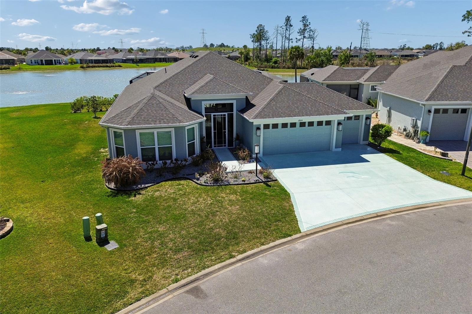 Experience the Essence of Living the Dream in this Beautiful Designer 4 Bedroom 2 Bath “Ivy” in the Village of Newell. This is the Best location in the villages with walking distance to all your activities and minutes away from the new Eastport area and Sawgrass square. The furniture is optional.  This home sits on .22 acres of property with an Extended Garage, Lanai, and Bedrooms. Explore everything the area offers with the the three year old "Evolution" golf cart included in the sale.  The large open floor plan is very Spacious with 10 Ft. Ceilings and Arched Entryways. The extra large Laundry room has built in cupboards and a Desk area that is Computer friendly and Includes the Washer and Dryer. The Kitchen has Smart Stainless Steel Appliances, Under and Over Cupboard Lighting, Beautiful Tile Backsplash and Elegant Quartz Countertops. The Sliding Stacking Doors open up to a Sparkling Tropical Oasis which consists of a Beautiful built in Pool and Spa overlooking a Large Pond with plenty of Wildlife. You will enjoy spending time on the large lanai with a brand new Rubber Floor and Hurricane Shades. The master bedroom gives you a Fantastic View of the Lanai and Pond. Inspired Closets are provided throughout the home. This Perfectly Landscaped Home with Double Door Entryway will make Everyone feel Welcome that comes through the door. Don’t miss out on this Hidden Treasure. The washing machine and dryer and full size refrigerator in the garage is also inculded, the furniture is optional.