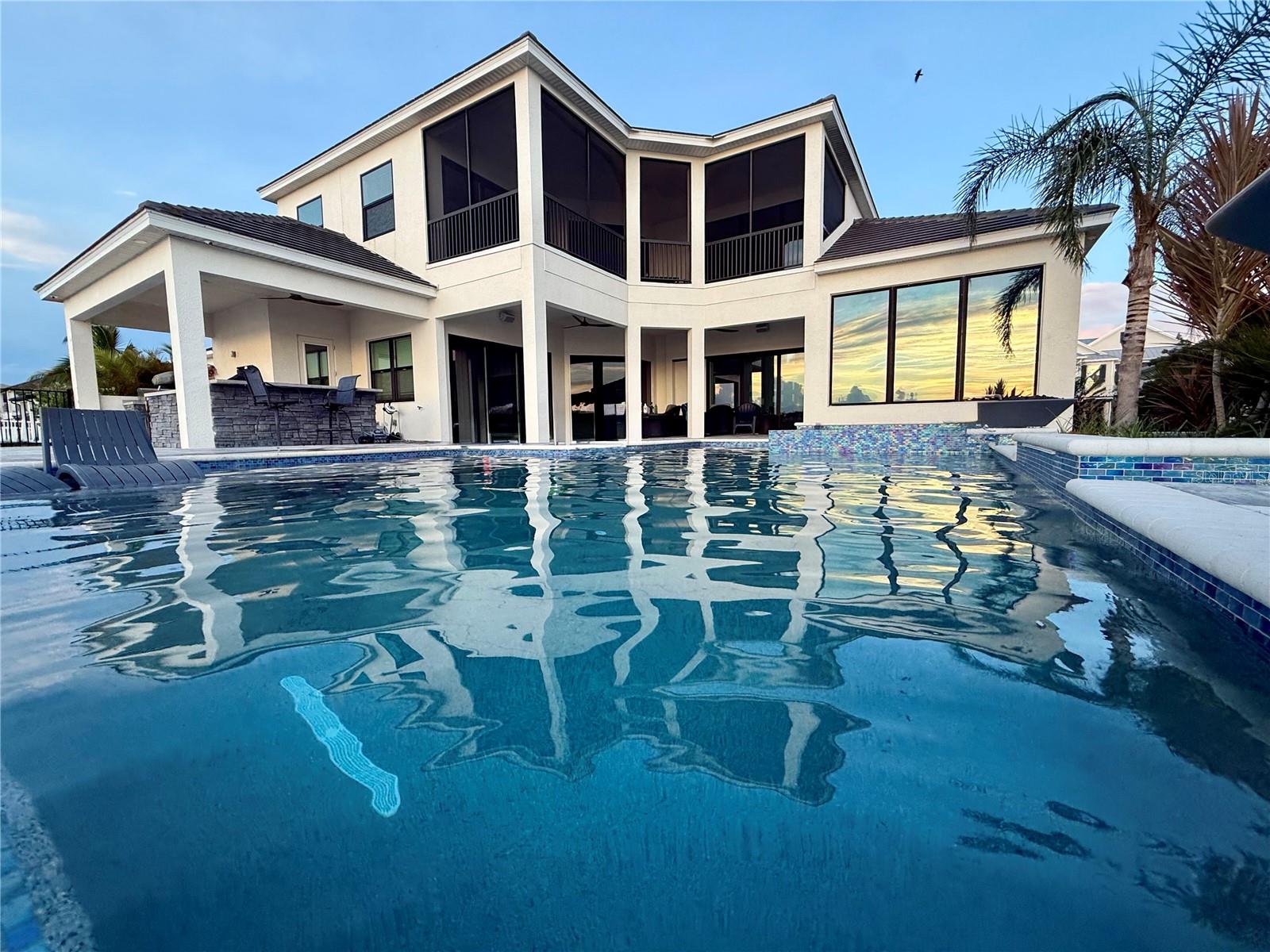 ***MARKET ADJUSTMENT*** MOTIVATED SELLER!!!  A true BOATERS PARADISE!!!  Don't miss out on this beautiful, custom waterfront home perched on the Manatee River with captivating sunsets and expansive water views!  The home offers unrivaled waterfront luxury and seamless indoor-outdoor living.  The generous-sized modern pool (6' deep with sun shelf, waterfall, 2 fire bowls), 6-person spa, oversized sun deck and outdoor kitchen (equipped with grill, beverage refrigerator, ice maker, sink, & storage) is ready to host all the family parties.  The dock includes LED lighting, potable water, electrical outlets, and 2 lifts, one 20k for your boat and one 10k platform lift for dual personal watercraft.

This stunning home offers 5 generously sized bedrooms with STORAGE GALORE, 4 full and 1 half bath, 3 living / entertainment areas, a dream kitchen with breakfast bar and expansive island, formal dining room, separate office, and oversized 3-car garage (additional 10' in depth and 9' doors) and driveway for ample storage and parking.  The primary bedroom is an owner's retreat, with dry bar, 2 walk-in closets with custom shelving and 2 additional built-in closets for abundant storage and organization.  The primary bathroom offers maximum relaxation with its generously sized free-standing tub and a shower with 3 shower heads and a Moen Spa system with 4 body jets.  This home includes allocated space for a residential elevator.

The Reserve at Harbour Walk community is a boater's paradise with direct access to the Gulf of America and Tampa Bay.  The neighborhood amenities include a kayak launch/storage, tennis courts, and a playground.  The community is also in close proximity to I-75, UTC Mall, diverse restaurants, shopping pristine beaches, and 3 major airports.