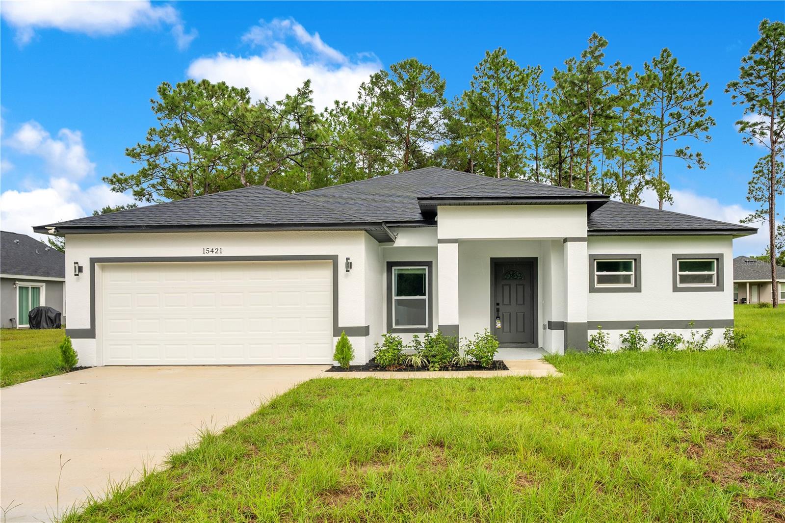 Under Construction. Under construction. I invite you to tour this beautiful brand-new 3-bedroom, 2-bath home offering 1,600 sq ft of living space, a 2-car garage, and no HOA or CDD. As you approach the home, you will appreciate the modern curb appeal, covered front porch, and inviting entry. Inside, the home is designed with a bright, open-concept layout, high ceilings, ceramic tile flooring throughout, and plenty of natural light. The kitchen is expected to feature shaker-style cabinetry, quartz countertops, stainless steel appliances, recessed lighting, a spacious island with seating space, and a functional layout perfect for everyday living and entertaining.

The split-bedroom floor plan offers privacy and comfort, with a spacious primary suite, walk-in closet, and an en-suite bathroom with dual sinks and modern finishes. The living area opens to a covered rear porch overlooking the backyard, creating a great space to relax or entertain. This home offers city water, septic, and a convenient Deltona location near shopping, dining, schools, parks, and major roadways.

Photos shown are representative/spec photos of a similar completed home and are for illustrative purposes only. Actual colors, finishes, fixtures, features, materials, accessories, and layout details may vary. Buyer and buyer’s agent to verify all measurements, finishes, taxes, construction status, completion timeline, and property details. Taxes may currently reflect land value only prior to completion.