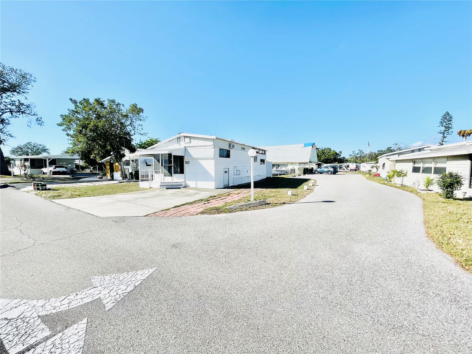 Welcome to the Gulf Of Manatee! For the same price as many of the vacant, lots in the area… with a little TLC this can be your paradise! Seller has kept the home clean and well maintained. Relax on the screened-in front porch, perfect for enjoying the Florida lifestyle. Enjoy a short walk to the swimming pool and pickleball courts. Beautiful corner lot conveniently located next to guest parking, offering easy access for visitors. You own the land, with a low HOA that includes water, sewer, and cable. Sugar Creek Estates is a gated community with its own amenities. This unique property features a small storage space, private laundry room, dining area, and kitchen. The original 5th wheel design includes a bedroom located up a few steps, with a double-wide addition providing a large living room that could potentially be converted into a second bedroom or expanded primary suite. MUST SEE! CONSUMERS SHALL EXERCISE DUE-DILIGENCE.
