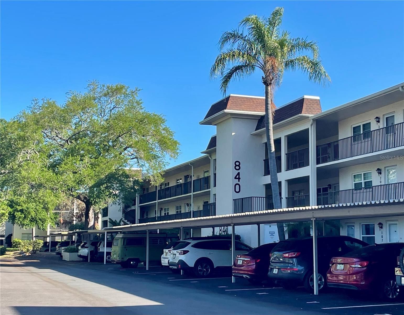 One or more photos have been virtually staged.
Welcome home to the highly desirable 55+ community of Patrician Oaks at the edge of downtown Dunedin.
This top floor unit is peaceful and serene with a view of green park like areas and gorgeous Oak trees.
Updates include a new roof in 2023, New HVAC in 2021 and 5 hurricane impact windows in 2015. 
This spacious two bedroom one bath has just over 1000 sq ft and is just waiting for your finishing touches in the kitchen and bath. 
The kitchen has plenty of storage and a pass-thru window that opens up into your large dining area and expansive living room, both perfect for entertaining. The primary bedroom can fit a king sized bed and there's plenty of storage with two double closets. The second bedroom  is large enough to double as a place for guests and an office space.
When you step through your sliders onto your private screened in lanai, you will be drawn in by the stillness and quiet. The large Oaks provide a privacy that makes you feel relaxed. Its the perfect spot for that morning coffee or afternoon tea, A secret oasis all your own.
There's also your own covered parking space right across from the elevator!

The community heated pool and clubhouse are steps away through a garden and wooden bridge. Enjoy the heated spa after a long day or meet friends at the clubhouse or fitness room.
The monthly fee includes cable, water, sewer, trash, grounds maintenance and more. There's also a free laundry room for the building with ample washers and dryers for your convenience.

Bike or walk to downtown and enjoy all the special spots in Dunedin known for, Whether it be the many cafes and restaurants, shops, breweries, art festivals, concerts, movies in the park or sunsets at the Marina. You'll realize that you've really found your piece of paradise..