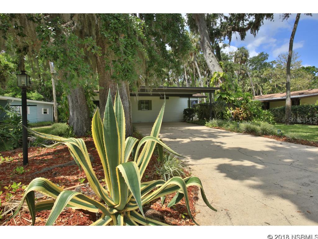 One of a kind floor plan with an open concept.  Entryway opens to kitchen and large living area which has a sliding glass door to the glassed-in, tiled Florida room that captures the entire backyard and natural area-so private and secluded. There are 2 wood decks for BBQ and relaxing.  New kitchen cabinets, countertops in 2004, New refrigerator and dishwasher in 2015. New Roof in 2015 -     Home is tiled and wood laminate in bedrooms.  Dining area has build-in storage space,  Slider off the master bedroom leads to the tiled Florida room.  Guest bedroom has a full size Murphy bed system with extra built-in storage.  Double carport -  Partially furnished. Short walk to path leading to the clubhouse, pool, hot tub, fitness center and fishing pier.  Loads of activities.  Resident private boat launch on the Intracoastal Waterway.  Come join the carefree lifestyle and drive around in your own golf cart in a gated Community. This Home is Move-In Ready and features Low HOA fees -- ;Water: City