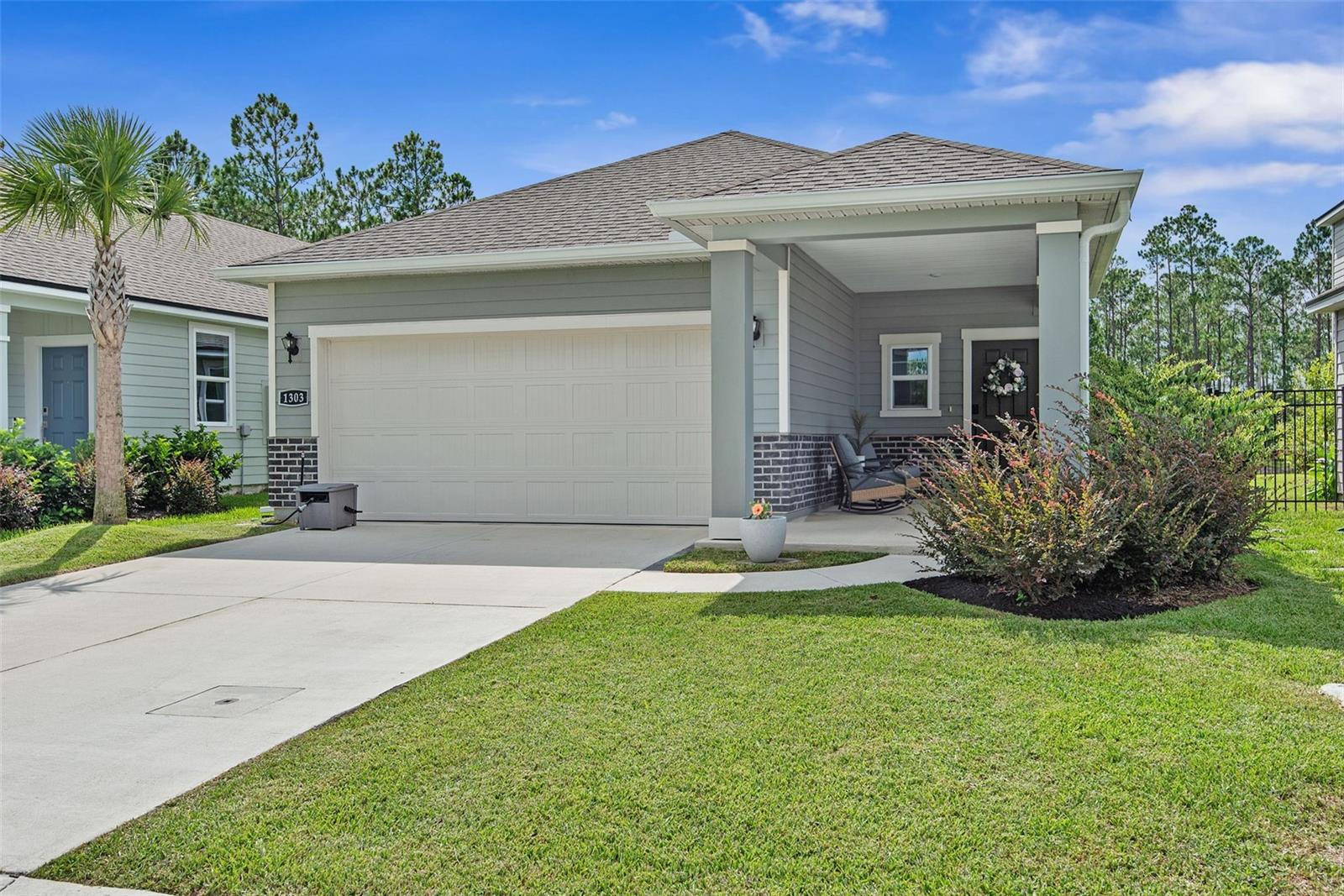 Welcome to this beautiful lakefront, practically new home in Seminole Palms, Palm Coast's newest master-planned community. Built by Century Communities, the popular Miramar floor plan offers 1,388 square feet of thoughtfully designed living space featuring 3 bedrooms and 2 full bathrooms. Perfectly positioned on a premium homesite with tranquil lake and wooded views, this home offers the ideal blend of privacy and natural beauty. Enjoy your morning coffee or unwind after a long day on the spacious covered lanai while taking in the peaceful surroundings. Inside, luxury vinyl plank flooring flows throughout the main living areas, complemented by stylish 42-inch cabinetry. The chef-inspired kitchen showcases elegant quartz countertops, a stainless steel microwave/oven combination, an electric cooktop, and an open layout that's perfect for everyday living and entertaining. With quality finishes, a desirable open-concept design, and an exceptional location in one of Palm Coast's newest communities, this move-in-ready home offers the perfect combination of comfort, style, and convenience. Why wait months for new construction when you can enjoy all the benefits of a like-new home today?