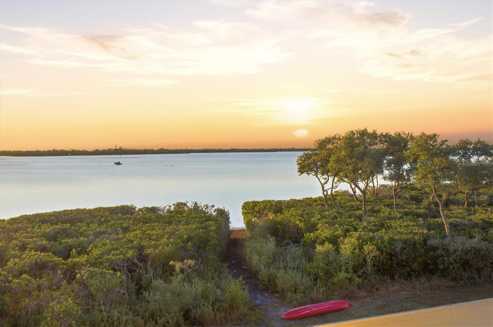 For those who appreciate the serenity and natural beauty of the Barrier Islands but prefer not to feel removed from essential conveniences, this location offers the perfect balance. Here, peaceful bayfront living meets the ease of having a golf course just steps away, creating a lifestyle where time on the water, time on the fairways, and time at home flow together seamlessly. Coastal relaxation, everyday practicality, and understated luxury combine to deliver an effortless way of living unique to Southwest Florida. Perfectly positioned along 111 feet of Lemon Bay waterfront, this contemporary home in the gated community of Eagle Preserve Estates offers exceptional coastal living with direct access to the Intracoastal Waterway. Located between the Lemon Bay Golf Course and Lemon Bay itself, and minutes from Boca Grande, the property combines privacy, water views, and a premier Southwest Florida lifestyle. The interior features luxury vinyl plank flooring, a private elevator, automated window treatments, and an enclosed waterside room with oversized picture windows that capture panoramic bay views. This climate-controlled space allows for year-round enjoyment of the waterfront setting. The chef style kitchen includes Quartz countertops, an induction cooktop, Microthermal microwave oven, Clear Cubes ice maker, Silgranite sinks, and a column refrigerator and freezer. Three ensuite bedrooms provide comfort and privacy for family and guests. The primary suite opens to a bayfront terrace with sunset views and includes two walk-in closets, dual vanities, an oversized walk-in shower, and a private commode. The lower level offers a large garage with 12 foot ceilings suitable for a car lift, a separate golf cart bay, workbench, cabinetry, two 50 amp outlets, and abundant storage. Outdoor amenities include a 47 foot heated saltwater lap pool overlooking Lemon Bay and a kayak accessible walkway for direct water access, with the ability to extend a dock if desired. This home is designed for recreation, relaxation, and refined waterfront living in Eagle Preserve Estates. Golf Membership is Not required.