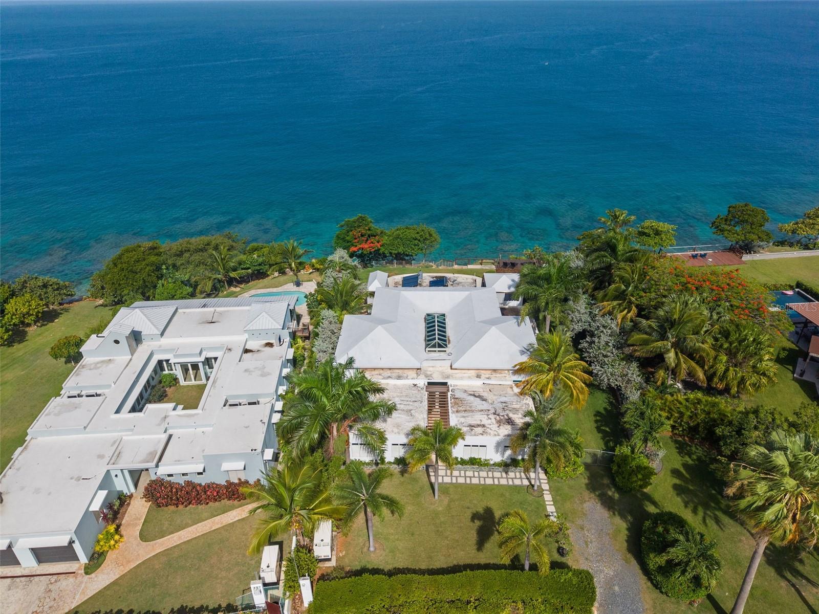 Perched high above the Atlantic on one of the most rare and coveted cliffside parcels on Puerto Rico’s west coast, this extraordinary oceanfront estate offers a once in a generation opportunity to own a true Caribbean trophy property. Tucked away on a dramatic hidden gem lot in Aguadilla, the property captures breathtaking panoramic ocean views and unforgettable sunsets that transform the horizon into a masterpiece of gold, crimson, and violet each evening.

Inspired by the elegance of Santorini architecture, the residence was thoughtfully designed to celebrate its surroundings. Expansive terraces, open living spaces, and sweeping views of the Atlantic create a seamless connection between indoor comfort and the beauty of the Caribbean Sea. The home features five bedrooms, six bathrooms, and multiple indoor and outdoor gathering spaces, perfect for both peaceful retreat and unforgettable moments shared with family and friends.

The outdoor living experience is truly magical. A stunning infinity pool appears to merge effortlessly with the endless blue horizon, offering a front row seat to the rhythm of the ocean and some of the most spectacular sunsets on Puerto Rico’s west coast. As the sun slowly sinks into the sea, the sky becomes a breathtaking canvas, creating an atmosphere that feels both serene and awe inspiring.

One of the property’s most remarkable features is its direct access to a secluded hidden beach below the cliffs. This beautiful stretch of coastline is known for its dramatic rock formations, crystal clear waters, and natural beauty that feels untouched and private. Few properties possess such rare and intimate access to a setting like this, allowing owners and guests to experience a true connection with the coastline.

Cliffside properties of this caliber are exceptionally scarce in Puerto Rico and rarely become available. Beyond its beauty and rarity, the property has also established itself as one of the top performing short term rentals on the west coast, making it a remarkable opportunity for those seeking both a private sanctuary and a luxury investment.

Adding to its appeal, Aguadilla is quickly emerging as one of the island’s most exciting destinations. The area is experiencing steady growth in real estate, a vibrant and expanding restaurant scene, and continued improvements to Rafael Hernández International Airport. Located just minutes away, the airport offers convenient access for both commercial and private flights, allowing owners and guests to arrive with ease and begin enjoying paradise almost immediately.
.
The combination of elevation, privacy, unobstructed ocean views, direct access to a hidden beach, proven rental performance, and unforgettable sunset vistas makes this a truly exceptional offering.

This is more than a home. It is a rare place where the beauty of Puerto Rico’s west coast, the sound of the ocean below, and the glow of the setting sun come together to create something truly extraordinary.