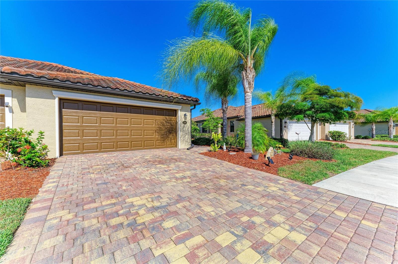 Welcome to this impeccably cared for model like villa tucked within the prestigious and highly desirable Gran Paradiso community in Venice. Surrounded by towering palm trees and vibrant tropical greenery, this refined home embodies the spirit of effortless Florida living while delivering an exceptional combination of elegance, comfort, and accessibility. 
Thoughtfully designed for contemporary living, the villa boasts a bright and airy open concept layout bathed in natural light through expansive windows and sliding glass doors. The generous living and dining spaces connect effortlessly to a beautifully appointed kitchen showcasing granite countertops, premium appliances, ample cabinetry, and extensive counter space, perfectly suited for both casual daily living and hosting guests.
The villa features two well appointed bedrooms, the home includes a flexible office and den area that can readily transform into a third bedroom, additional guest space, or a quiet private study, providing adaptability for a wide range of lifestyles. 
The primary suite functions as a serene personal sanctuary, complete with dual closets, and a luxuriously finished ensuite bath boasting double vanities, a deep soaking tub, and a generously sized walk in shower. The guest bedroom is spaciously appointed and provides plenty of room for family and overnight visitors, while the second bathroom is elegantly designed with a refined vanity and a practical tub and shower combination.
The private screened lanai is a charming outdoor haven adorned with crafted brick pavers, ideal for soaking in the peaceful tropical atmosphere surrounding you.
Gran Paradiso residents benefit from an outstanding array of resort inspired amenities, including a stunning community pool, a fully equipped fitness center, and meticulously landscaped walking paths winding throughout the neighborhood. Whether you lean toward an active routine or quiet relaxation, this thriving gated community has something to offer every resident.
Perfectly positioned near the flourishing Wellen Park corridor, homeowners enjoy easy access to a diverse selection of dining, specialty shops, cozy cafés, entertainment options, and lively community gatherings. CoolToday Park, is the official spring training venue of the Atlanta Braves, provides year round events ranging from sporting activities and concerts to neighborhood festivities that contribute to the area's energetic character. A brief drive leads you to Historic Downtown Venice, where you'll discover eclectic boutiques, alfresco dining, weekly farmers markets, art showcases, live performances, and the warm charm of a classic coastal community.
Venice is celebrated for its breathtaking Gulf Coast beaches, picturesque nature trails, and abundant outdoor pursuits including boating, kayaking, fishing, and golf, all set against the backdrop of spectacular sunsets. The region is recognized for its close knit community spirit, outstanding medical facilities, highly regarded schools, and straightforward access to Interstate 75, putting Sarasota, Fort Myers, Tampa, and the broader region well within reach.
Whether your vision is a seasonal getaway, or a permanent place to call home, this villa represents a remarkable chance to immerse yourself in the resort style living Gran Paradiso offers and discover the very finest that Venice, Florida has to give.