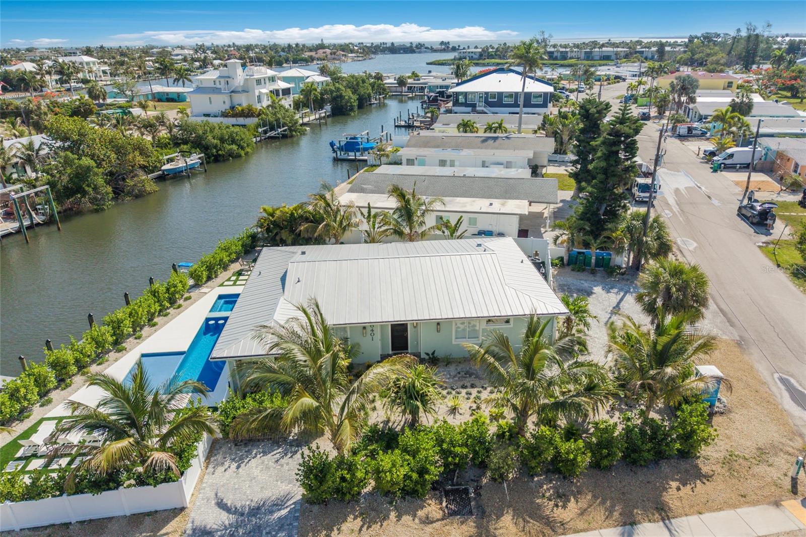 Welcome to an extraordinary waterfront retreat on beautiful Anna Maria Island featuring over 100 feet of deep-water canal frontage, private dockage, direct Gulf access with no bridges, and the rare advantage of weekly rentals allowed, making it an exceptional investment opportunity. Fully reimagined by Eason Builder Group, this stunning 3-bedroom, 3.5-bath coastal residence blends elevated luxury craftsmanship with effortless island living — offering exceptional boating access, resort-style outdoor spaces, walkability to the beach, and outstanding income-producing potential. From the moment you arrive, lush tropical landscaping and timeless coastal architecture create an immediate sense of relaxed sophistication. Inside, every detail has been thoughtfully curated with custom millwork, wood coffered ceilings, wide-plank flooring, designer lighting, layered textures, upscale furnishings, and beautifully integrated indoor-outdoor living spaces. The open-concept floor plan centers around a spectacular chef’s kitchen featuring premium appliances, quartz countertops, custom cabinetry, designer tilework, statement pendants, and a handcrafted wood-accent range hood. Each bedroom feels like a private boutique retreat, including a custom-designed bunk room ideal for hosting guests and maximizing luxury vacation rental appeal. Spa-inspired bathrooms showcase elevated tile selections, custom vanities, and refined coastal finishes throughout. Outside, the home transforms into a true private island resort with a spectacular pool and spa, expansive sun deck, tropical landscaping, multiple lounge areas, outdoor dining spaces, and a fully equipped summer kitchen designed for unforgettable entertaining. For boating enthusiasts, the private dock provides effortless access for boats, paddleboards, kayaks, and jet skis — perfect for exploring nearby sandbars, waterfront restaurants, and the turquoise Gulf waters. Located moments from Anna Maria Island’s famous white sand beaches, Pine Avenue boutiques, cafés, and waterfront dining, this exceptional furnished property is perfectly suited as a luxury primary residence, island getaway, or high-performing vacation rental investment offering the ultimate island lifestyle.