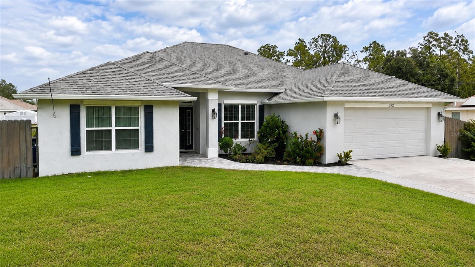 One or more photo(s) has been virtually staged. Ask about receiving UP TO $17,000 IN BUYER ASSISTANCE THROUGH THE PREFERRED LENDER, subject to loan program guidelines, application, qualification requirements, lender approval, and available programs. Welcome to 372 Rockland St, Lehigh Acres! This spacious and well-maintained ADAMS HOMES FLOOR PLAN offers 4 BEDROOMS, 2 BATHROOMS, A FLEX ROOM, AND A 2-CAR GARAGE with over 2,300 square feet of comfortable living space. Built with CONCRETE BLOCK CONSTRUCTION, this home features a desirable SPLIT BEDROOM FLOOR PLAN, VAULTED CEILINGS, a spacious FAMILY ROOM, formal dining area, breakfast nook, and a functional EAT-IN KITCHEN complete with WOOD CABINETS, LIGHT BLUE BACKSPLASH, PANTRY, GARBAGE DISPOSAL, and ICE MAKER REFRIGERATOR. The primary suite offers DUAL SINKS, a COMBINATION TUB/SHOWER, and a large WALK-IN CLOSET. The guest bathroom features a WALK-IN SHOWER for added convenience. Additional highlights include CLOSET SHELVING THROUGHOUT, MULTIPLE LINEN CLOSETS, LARGE PANTRY, DEEP UTILITY SINK, WATER SOFTENER SYSTEM, REUSABLE HVAC FILTER, BRAND NEW WASHER & DRYER (2026), BRAND NEW STOVE (2026), and a GENERATOR-READY CONNECTION FOR BACKUP POWER. Enjoy Florida living from the oversized 13' X 30' SCREENED AND TILED LANAI overlooking a FULLY FENCED BACKYARD with CONCRETE WALKWAYS AROUND THE HOME, plenty of room for entertaining, pets, or a future pool. Additional peace of mind comes from the HURRICANE SHUTTER PACKAGE, ENERGY-EFFICIENT THERMAL WINDOWS, BRAND NEW GUTTERS, and TWO GARAGE DOOR OPENERS. Conveniently located near shopping, dining, schools, and major roadways with NO HOA restrictions. Schedule your private showing today!