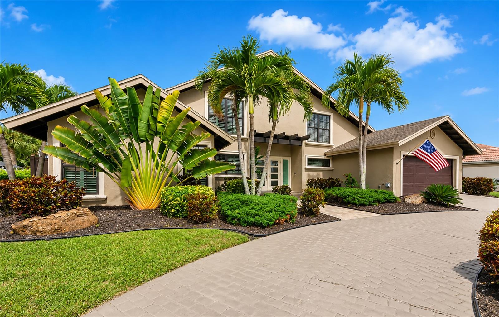 Elevated luxury throughout this Southbay beauty!  Step inside this one of a kind two story home and you will feel like you are a top notch resort!  You will enter the foyer overlooking the living room and dining room area, just perfect for entertaining highlighting a built-in buffet with wine cooler.  Open the sliding glass doors ahead and enter the exquisite out door living area, heated salt water pool, hot tub, outdoor kitchen and dining area, all adding up to the feeling of relaxed elegance. The kitchen is a dream! Top of the line Thermador appliances including a smooth induction top stove, built in oven and microwave and for the ultimate in extravagance - a built in Thermador coffee maker.  Quartzite counter tops, over sized island, custom pantry, sliding glass doors to exterior help complete this gathering spot.  Located on the first floor is the spacious master suite with triple sliding doors looking onto the lanai area. Master bath with tub and an oversized window looking onto a private zen garden.  The spacious second bedroom currently used as an office features corner windows and has a full luxury guest bath right out side its door.  The oversized family room with vaulted ceiling and wood beam accents will be a great family retreat with a built in new state of the art fireplace and TV.  Unique pebbled wallpaper adorns one wall to help maintain the resort feel.  First floor laundry with built in cabinets is also on the first level.  Upstairs you will find two nice sized bedrooms plus a full bath with double bowl sinks.  The upstairs bonus room is a fun hideaway for a play room, office, or workout room, featuring glass French doors.  Plenty of storage in this home with several attic accesses. Other important features include plantation shutters through-out, one new A/C unit in 2025, attic TAP insulation installed 2025, stackable washer and dryer 2024, new GAF coating on TPO flat roof (lanai), interior painted 2024, extensive landscaping 2025 including addition of a side private patio, and lanai wood ceiling 2025 and new hurricane rated glass in double front door. All the beautiful furnishings  and decor items in the home are negotiable as well.  So many more details you will just have to come and see for yourself.  The Southbay Yacht and Racquet Club is a vibrant community with many amenities, activities and offers it’s own marina to residents.  The marina dock fees are low and has space for most boat sizes.  Also in the marina is a kayak launch and storage on site.  The renovated clubhouse offers a fitness center, 99 person ballroom, livingroom, two kitchens, pool, bocce balls, tennis and pickleball. Centrally located between Sarasota and Venice, area beaches, restaurants and shopping.  The local favorite restaurant, Casey Key Fish House & Tiki Bar is right down the road!  Southbay is a fabulous place to live and play - and as they say, come and buy your boat a home!