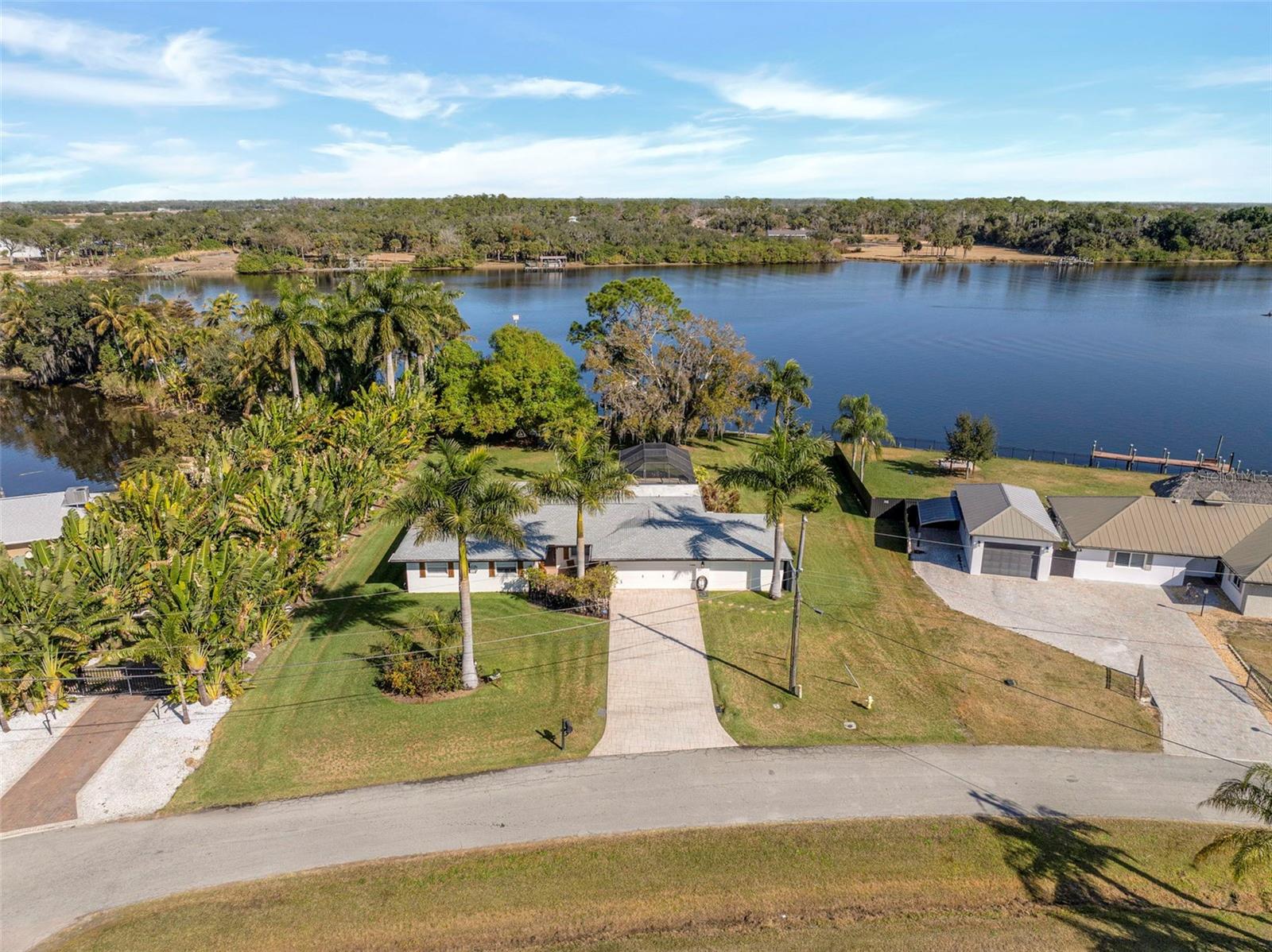 Experience true Southwest Florida waterfront living with this exceptional direct riverfront property offering immediate boating access to the Caloosahatchee River and the Gulf beyond. Set on over half an acre, this oversized homesite provides rare space, privacy, and flexibility to enjoy the lifestyle you’ve been dreaming of. With unobstructed river frontage, this property is ideal for boating enthusiasts seeking open water access right from their backyard, all while tucked within a quiet residential setting. Mature trees and expansive yard space create a peaceful, private atmosphere, and in the evening the property transforms into a beautiful retreat with solar lanterns hanging from the oaks and thoughtfully placed landscape lighting throughout the grounds. Inside, the home has been extensively updated, offering a move-in ready interior with quality finishes throughout. Porcelain tile flooring runs through the main living areas, providing both durability and a clean, modern aesthetic, with tile in the bathrooms for a cohesive look. The home also features a new roof (2022) and new AC system (2022), adding significant value and peace of mind. Additional updates include doors, trim, cabinetry, sinks, and appliances, all contributing to a cohesive and refreshed interior. Large windows fill the home with natural light and showcase expansive river views, while the functional layout supports comfortable everyday living. An electric interior fireplace adds warmth and ambiance, creating an inviting focal point in the main living space. With generous space, direct waterfront access, and no high-density surroundings, this property is well suited for those seeking privacy, long-term value, and a true Florida lifestyle. Whether you’re searching for a primary residence, seasonal retreat, or waterfront investment, this home offers a rare combination of location, updates, and natural beauty.