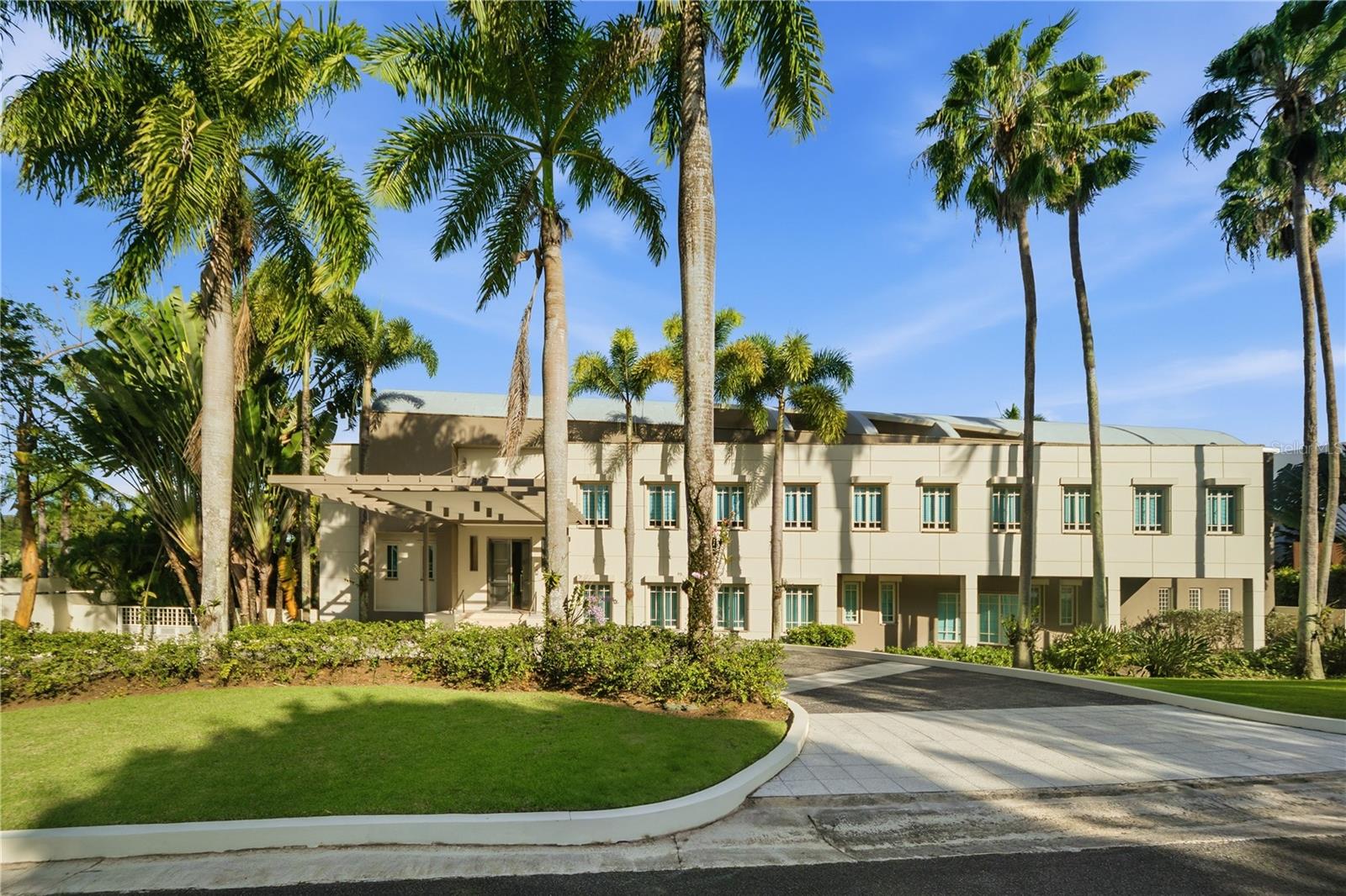 Nestled on 1.2 acres, 9 Castaña St. represents a rare opportunity to own a multigenerational estate within San Juan’s premier gated community, San Patricio.

Designed by award-winning architect Carlos Betancourt, the residence masterfully balances grand-scale entertaining with a layout that remains intimate and connected, ensuring comfort for every member of the family.

The resort-style outdoor spaces create a private sanctuary in the heart of the city, featuring a fully equipped outdoor kitchen, spa-inspired pool and jacuzzi, basketball court, outdoor air-conditioning system, tranquil koi pond, and a chicken coop.

Inside, the home showcases soaring ceilings and expansive living areas, including multiple formal and informal gathering spaces, a game and media room with direct access to the outdoor entertaining areas, and a fully equipped private gym.

Offering over 10,000 square feet of refined living space, the residence includes 7 bedrooms, 8 full bathrooms, and 2 powder rooms. On the main level, doors open throughout, creating a seamless indoor-outdoor flow, connecting the interior living spaces to the beautifully designed outdoor areas.

Additional features include a double backup generator with automatic transfer switches and a 6,000-gallon cistern with a water treatment system, ensuring comfort and reliability year-round.

The property has a covered carport for 4 vehicles, along with additional driveway parking.

Centrally located, this home is approximately 10 minutes from the Condado area and 25 minutes from Dorado.
