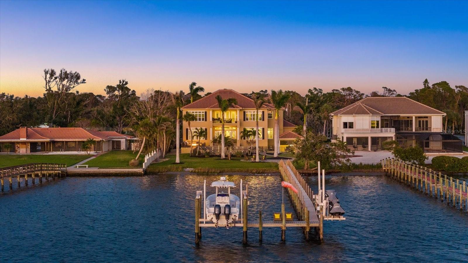 Boater’s Paradise – A Waterfront Masterpiece

Nestled on 1.37 acres of pristine waterfront along Lemon Bay and the Intracoastal Waterway, this ultra-luxury estate is a sanctuary of elegance, offering unparalleled privacy and breathtaking views. Surrounded by lush tropical landscaping and majestic royal palms, this exceptional residence blends refined design with the finest in coastal living.

Designed for both grand entertaining and intimate retreats, the home features five spacious bedrooms, five baths, and a stately executive office with a walk-in closet. A newly installed 2023 elevator ensures effortless access throughout. Boating enthusiasts will appreciate the 2018 composite dock, complete with electric, water, a 12,000-pound boat lift, and two jet ski swings, while the 2020 RV/boat barn offers ample storage for a Class A motorcoach, a boat, or up to five vehicles. An oversized three-car garage, resurfaced with a polyaspartic finish, adds to the home’s impressive accommodations.

The expansive primary suite, located on the first floor, is a true retreat, featuring breathtaking water views, two walk-in closets with custom cabinetry organizers, and a spa-like ensuite. Designed for indulgence, the ensuite boasts dual sinks, a makeup vanity, a soaking tub, and a walk-in shower that serves as the focal point—featuring both a wall-mounted shower head and a luxurious rain shower. Upstairs, four generously sized guest suites each offer an ensuite bath, providing comfort and privacy for family and guests.

Entertaining is effortless with a thoughtfully designed layout, offering a formal living room, a cozy family room, and a grand kitchen with an abundance of cabinetry and countertop space, and a dinette, while the formal dining room sets the stage for elegant gatherings.

At the heart of the home, the chef’s kitchen is a masterpiece of both form and function, featuring a Sub-Zero refrigerator, Wolf 48” range and microwave, paneled dishwasher, stunning granite countertops, two breakfast bars, and an amazing butler’s pantry with built-in cabinetry, offering additional storage and prep space for seamless entertaining.

The outdoor oasis is designed for resort-style living, featuring a resurfaced saltwater pool and spa with LED lighting, a new cabana with a covered entertaining space, and an outdoor kitchen with composite cabinetry, a built-in grill, exhaust hood, sink, and storage for boating essentials. New pavers, a decorative pool fence, a firepit, and a paver terrace with a built-in propane fire table complete the exceptional outdoor living experience.

This waterfront property is set in a truly unique location, offering both tranquility and convenience. Boaters will love the easy access to open water, with the Gulf of Mexico just 20 minutes north via the Venice Jetties, or 20 minutes south via Stump Pass. The vibrant lifestyle of the area is within easy reach, with boutique shopping and fine dining just a 10–20 minute drive away.

Built with security and efficiency in mind, the home is elevated on a stem wall, fitted with PGT impact windows with thermal tint, and experienced NO WATER INTRUSION in the living space. The owned 2023 solar system keeps electric costs remarkably low at approximately $27 per month. Additional features include public water, a well for irrigation, Fiber FIOS, a security system, and a long, high-quality concrete driveway.

Video: https://iframe.videodelivery.net/550bfc84fca6ea91d0ee87961165fa2b