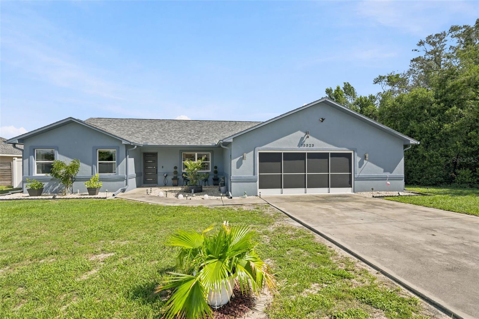 Welcome Home to this well-maintained 3-bedroom, 2-bathroom home with an oversized 2-car garage and a bumped-out workshop/storage area. The garage has a screen. The primary bedroom is split from the secondary bedrooms, providing privacy and an en-suite bathroom with walk-in shower with bench and walk-in closet. The second bathroom has a tub/shower combo. Much of the home has tile. The 3 bedrooms have carpet. One of the secondary bedrooms has a double closet. The kitchen has a large eat-in space and is open to the living room and dining room/billiard room. There is an additional den off this main area, allowing for plenty of space for gatherings/entertaining. There is an inside laundry room with a door to the side of the property, which can double as a mud room. You can access the garage from the kitchen or the hallway by the laundry room. This property is fully fenced with an in-ground pool and firepit. The decking around the pool is pavered. NO HOA!! NO CDD!! Windows are double-paned. The front door and back doors were replaced in 2024. Newer floors throughout.  Exterior newly painted. ROOF 2023. This home will not disappoint!! Close proximity to the Suncoast, shopping, restaurants, medical, and entertainment.