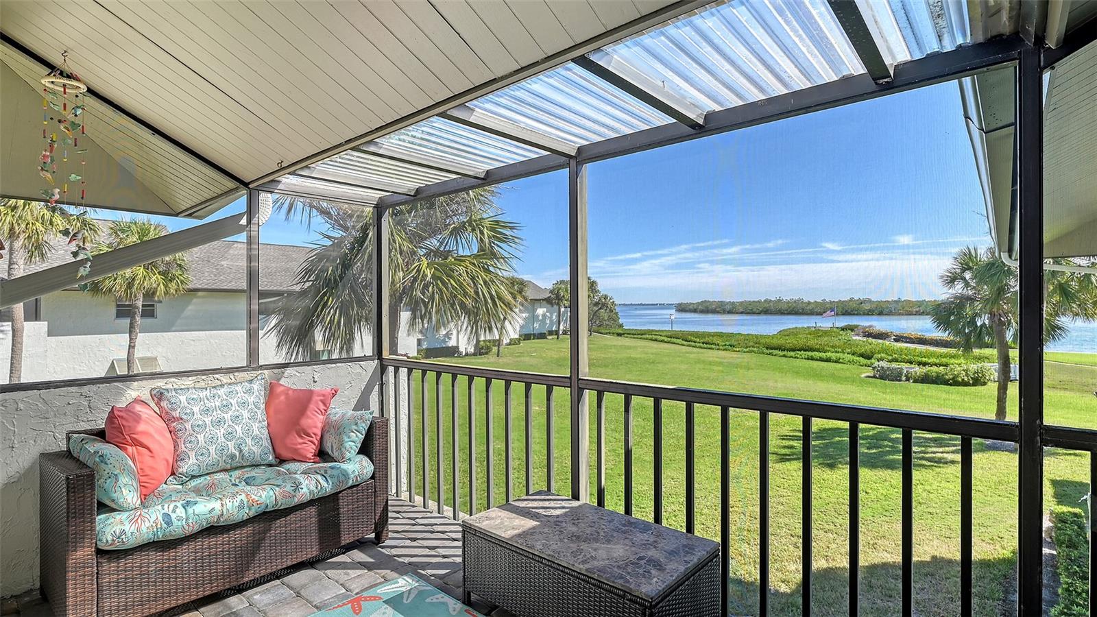 Beautiful, custom 2024 renovated second floor two bedroom, two bathroom Pelican Harbour & Beach Club condo with panoramic Sarasota Bay views plus Deeded Beach access right across the street.  Stunning water views across Sarasota Bay are yours from the Great Room, the Primary Bedroom & from your waterfront, covered & screened in Balcony. Entertain your guests here or enjoy your own private dining outdoor lanai.  Almost everything is new & improved in this open concept, sunny & bright home from updated electrical to new impact resistant hurricane proof sliders & windows throughout.  You’ll really enjoy the large new window in the kitchen with great views of the pool so you can keep an eye on family & grandchildren. The totally redesigned kitchen features all new custom raised panel cabinetry with soft close drawers, light gray with graining Quartz center island & kitchen counters, Frigidaire Gallery induction cooktop, white subway tile back splash & built in Whirlpool microwave & oven.  Newly installed Luxury Vinyl Plank flooring is 9” wide plank in a light oak color. Other improvements include a wine refrigerator, a n HVAC system installed in 2023 plus a new roof on this building in 2024 & exterior painted in 2024. The Sellers have invested close to $100,000 to accomplish this stunning remodel. The open floor plan features a large Great Room which includes the dining area & the living room with several couches plus a double bed size Murphy bed attractively hidden between two built in bookshelves & cabinetry for extra sleeping accommodation.  The generous sized Primary Bedroom with En Suite bath has serene waterfront Bay views with sliders opening to the screened in balcony.  The En Suite features dual sinks, a custom walk-in tub/shower combo & a Toto toilet. The second guest bedroom is bright & comfortable with an adjoining bath with a shower. Bonus feature of the in unit laundry room is a full size LG high efficiency washer & dryer. There is abundant storage room in this unit especially in the number of new kitchen cupboards, storage areas & closets. Assigned storage lockers are also available in the mail room. Pelican Harbour & Beach Club condominium complex offers one of the best Amenity packages on Longboat Key including 200 feet of private deeded beach with new lounge chairs and beach side bathroom, resort style heated pool, adjoining clubhouse, marina with newly built boat docks and fishing docks for boats up to 28 feet with Sarasota Bay frontage of 800 feet, kayak storage & launch area and is large dog/pet friendly complex plus has tennis & pickleball courts which have recently been renovated & painted. On site maintenance staff plus a professional management company, funded reserves and has successfully passed its milestone inspection for the beach side midrise condo building plus has installed brand new roofs & hurricane rated carports. None of the units in this building sustained any damage from hurricanes Helene or Milton or had any water intrusion. Pelican Harbour’s perfect location at Mid Key Longboat is close to all the best restaurants & shops on Longboat Key and Bay Front Park which offers walk in pickleball games, tennis courts, dog park areas plus an exercise/fitness classes building.