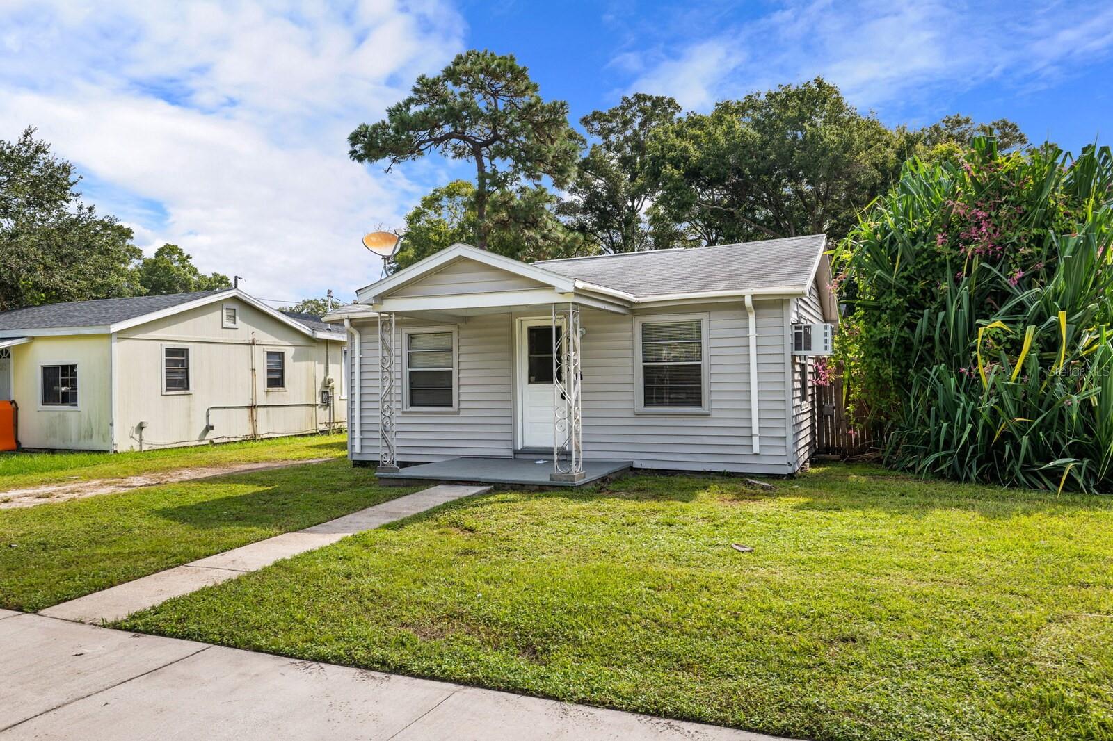 Househackers and investors, this is Unincorporated Pinellas County! Rare two houses on one lot! Nestled in the heart of North St. Petersburg, this unique property offers a rare opportunity each with its own mailing address, electric meter, and fenced yards for added privacy. 1 Shared water meter.  Perfect for investment, multigenerational living, or simply enjoying a guest house, this property is full of potential. The first home, located at 5101 and facing 37th St N, features a light-filled floor plan with laminate flooring. A short walk through the garden gates leads to 5101.5, a second charming 2-bedroom, 1-bath home. This home boasts beautiful flooring, new appliances, granite cmeterountertops, and updated kitchen cabinets. It also features a private fenced yard and a lovely garden space just outside the front door with tons of potential. An on-site shared laundry room and a storage shed adds convenience.  Its central Lealman location just off 34th St N provides convenient access through St. Petersburg and surrounding Pinellas County. Leased at $1,445/month through 10/31/2026 and the second leased at $1,375/month through 02/28/2027, giving buyers income in place from day one.