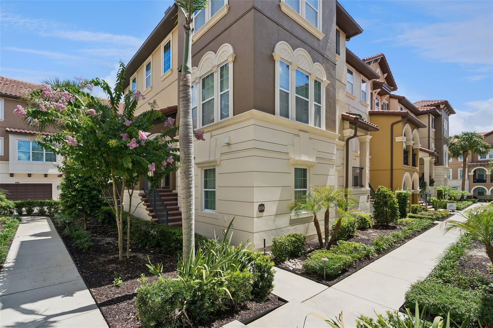 One or more photo(s) has been virtually staged. MOVE-IN READY and beautifully refreshed, this highly sought-after END UNIT Torino floor plan by Ashton Woods is located within the prestigious 24-HOUR GUARD-GATED community of Fountain Parke and offers OVER 2,500 SQFT of maintenance-free living. Recent improvements include FRESH INTERIOR PAINT, BRAND-NEW CARPET, a NEVER-USED STAINLESS STEEL FRENCH DOOR REFRIGERATOR, and a BEAUTIFULLY UPDATED KITCHEN featuring PROFESSIONALLY REFINISHED CABINETS with BRAND-NEW CABINET DOORS, DRAWER FRONTS, AND MODERN HARDWARE. Surrounded by lush landscaping and ideally situated along the outer edge of the community, this home offers exceptional privacy while boasting one of Fountain Parke's largest floor plans with 4 BEDROOMS, 3.5 BATHS, A LOFT, PRIVATE COVERED BALCONY, and a 2-CAR GARAGE. The first floor features an oversized bedroom with a full en-suite bathroom, making it ideal as a SECOND PRIMARY SUITE, IN-LAW SUITE, HOME OFFICE, OR MEDIA ROOM. The second floor offers an expansive great room, formal dining area, and an upgraded kitchen complete with 42-INCH WHITE CABINETS, GRANITE COUNTERTOPS, TILE BACKSPLASH, STAINLESS STEEL APPLIANCES, and the BRAND-NEW FRENCH DOOR REFRIGERATOR. The third floor features the spacious primary suite, two additional Jack-and-Jill bedrooms with a connected bath, a versatile loft, and a conveniently located laundry closet. Enjoy the MAINTENANCE-FREE lifestyle Fountain Parke is known for with RESORT-STYLE AMENITIES including a pool and spa, fitness center, tennis courts, dog park, playground, putting green, and beautifully maintained grounds. Conveniently located within the highly sought-after Seminole County School District and just minutes from shopping, dining, medical facilities, I-4, and SR-417, this home offers the perfect combination of luxury, privacy, and convenience. Schedule your private showing today!