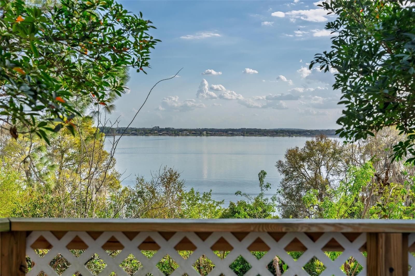 *PRICE IMPROVEMENT*A rare opportunity to own a magnificent .85-acre lakeshore estate on the famous shores of Lake Dora. Over 5,000 sq. ft. of living space and more than 200 ft.of pristine lake frontage,this completely renovated Cape Cod offers a lifestyle of luxury, breathtaking sunset views, & unparalleled flexibility.Arrive through a tranquil zen garden with a peaceful pond & choose between two inviting entrances.Step inside to a timeless foyer, where stained-glass windows and an elegant chandelier cast a warm glow, leading you into a dramatic hallway that hints at the classic craftsmanship throughout.This multi-story home is designed for both grand entertaining and intimate daily life.Features 3 bedrooms and 3.5 bathrooms,with with room to expand, you're also protected by a whole home generac generator .The main level includes a bespoke Library, anchored by a wood-burning fireplace and a wall of windows overlooking the lake.This space,which was the original  1st floor primary suite,can easily be reconverted with its en-suite bath and private entrance to serve as a 4th bedroom or a private mother-in-law suite.The award-winning chef's kitchen is a dream,featuring Wolf and Sub-Zero appliances,a multi-functional island with a gas wok burner and refrigerator drawers,two warming drawers,and handcrafted hickory cabinetry.Adjacent to the kitchen, a sunlit breakfast nook overlooks the grounds,while a formal dining room provides the perfect setting for dinner parties and holiday gatherings.The heart of the home is the unforgettable Great Room.Exposed beams and a striking floor-to-ceiling stone fireplace with a grand mantel are framed by a massive 22-foot picture window,capturing postcard-perfect views of Lake Dora.For more formal gatherings,the elegant living room, known as "The Red Room," offers a second wood-burning fireplace and timeless charm.Step onto the large circular wooden deck to watch spectacular sunsets over the water.Below, discover your own curated edible landscape,a sanctuary garden brimming with fruit trees, fresh herbs,& dedicated greenhouse for the avid gardener.Additional private decks and a large front balcony overlooking the zen garden provide quiet spots for morning coffee or evening reflection.The grand basement reveals a remarkable climate-controlled cedar wine cellar and an exceptional bar and entertainment lounge.This space is complete with a cooktop, dishwasher, and a luxurious bathroom with a double vanity and a walk-in travertine shower with a rain-shower head.With its own entrance, this level is ideal for guest quarters, a rental apartment, or the ultimate entertainment lounge.(Note: The lower level's square footage is in addition to the public record of 4,151 sq. ft.)A 115-square-foot art studio off the Library, equipped with a sink, is perfect for a workshop, hobby room, or creative space.· An additional 500 sq. ft. of finished attic space presents an opportunity to add even more value, bringing potential living space to nearly 5,500 square feet.The property comprises two waterfront parcels. This offers the unique potential to retain a sprawling legacy compound or, with the appropriate city approvals, explore the possibility of a future build site, a concept already met with positive feedback from the City of Mount Dora Planning department.This is more than a home;it's a waterfront sanctuary where classic elegance meets modern luxury, just waiting for its next chapter. See attachments for survey and floor plans