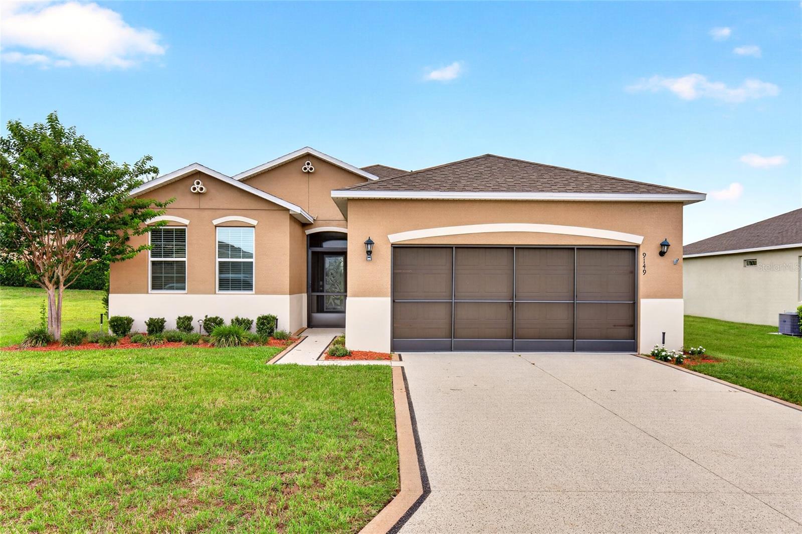 One or more photo(s) has been virtually staged. Located in gated 55+ community of JB Ranch with low Hoa of $215/ month which includes the home lawn care plus 2019 amenities such as pool, clubhouse, fitness center and pickleball courts!
This lot is the 2nd largest lot in JB Ranch, it has a large side yard and no neighbors directly behind with the pond. Custom painted and stamped driveway leads to screened in front covered entry. The home features spacious open floor plan, no carpet, all tile and luxury vinyl plank, 2 car garage with epoxy floor and upgraded garage door screen, roof 2019 hvac 2019  with HVAC system upgraded with ultraviolet (UV) air purification/sanitizing system designed to assist with air quality and HVAC cleanliness.
and hot water heater are 2019. Step into your new home into the foyer , to left is 2nd bedroom and 2nd full bath across the hallway is home to 3rd bedroom and laundry room. Entering the open floor plan from this area your are greeted to the focal point of home in the living room and kitchen overlooking the covered and screened lanai and unobstructed pond views! The large living room has plenty of room to watch the game or entertain, the living room overlooks the kitchen with stainless steel appliances, walk in pantry, granite countertops and an island with room for 4 bar stools. The dining area is shared with the kitchen. Privately position if far right corner is the primary bedroom with walk in closet and primary bath with double vanities, and a glass and tile surround shower. Returning to main living area leading out to covered and screened lanai you exit through the triple sliders with Epoxy flake flooring and Ceiling fan. The backyard overlooks the pond with plenty of room to add a pool if you wish. Home was originally equipped with builder-installed smart home features/system