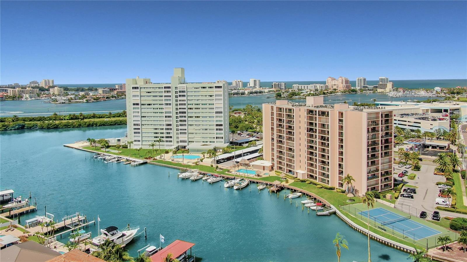 BEST DEAL IN CLEARWATER BEACH – INCREDIBLE WATER VIEWS!  Welcome to your dream beach retreat at 51 Island Way! From the moment you step inside this light-filled, oversized 1-bedroom, 1-bath condominium, the breathtaking panoramic views immediately steal the show. Enjoy sweeping vistas of the Intracoastal Waterway, marina, heated pool and spa — and yes, you’ll love watching dolphins, manatees, and Florida’s beautiful coastal wildlife right from your PRIVATE BALCONY.  Interior Highlights Include: Open floor plan designed for seamless indoor/outdoor living, Oversized private balcony with HURRICANE-IMPACT-RATED sliding glass doors, King-sized primary bedroom with balcony access and water views and a Custom walk-in closet, Ceramic tile throughout, Electrical panel (2025) Range (2023) Refrigerator (2023) A/C (2017). This move-in ready residence offers comfort, functionality, and unbeatable scenery. Resort-Style Living in Island Estates: Located in one of the most desirable waterfront buildings in Island Estates, owners enjoy secured keyless entry into a newly renovated lobby and an impressive array of amenities: Private marina, Kayak storage & launch, Oversized heated waterfront pool & spa, Waterfront tiki tables & tiki bar, Renovated his & hers restrooms with showers & sauna, Shuffleboard court, Tennis court and BBQ area. Prime Location and just a short walk to: The #1 Beach in the U.S. – Clearwater Beach, Pier 60, Top-rated restaurants & shopping, Publix and Much more. The Clearwater Jolley Trolley conveniently stops right in front of the building, making it easy to explore everything the area has to offer. This property is priced to sell and won’t last long.  Call today to schedule your private showing and make this waterfront paradise yours!