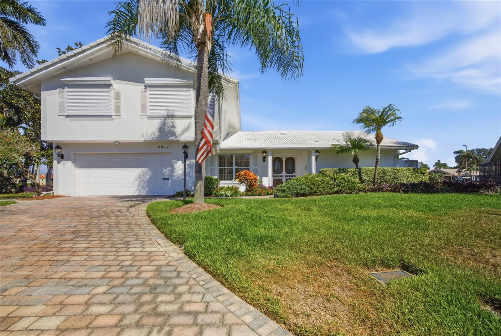 Tucked away on a quiet south-facing cul-de-sac, this exceptional residence commands an extraordinary 170 feet of open water frontage, creating a private coastal retreat where every sunrise, boat ride, and sunset becomes part of everyday life. With 3,177 square feet of beautifully designed living space, four bedrooms, and four-and-a-half bathrooms, this home effortlessly blends timeless elegance with the relaxed sophistication of Florida living. Natural light pours through the home, accentuating soaring ceilings, spacious living areas, and picturesque water views from nearly every angle. Whether you're gathering in the formal dining room, relaxing beside the fireplace in the living room, or preparing meals in the bright eat-in kitchen, every space is designed to embrace the beauty just beyond the windows. The first-floor primary suite offers a private sanctuary, while generously sized guest bedrooms provide comfort and flexibility for family and visitors alike. Step outside, and the lifestyle truly begins. Lounge beside the pool, host unforgettable evenings on the expansive waterfront deck, or cast off from your private dock for a day on the open water. With no fixed bridges between your dock and Tampa Bay, boaters can enjoy unrestricted access and accommodate vessels of virtually any size. With ideal southern exposure and expansive waterfront, this property is a rare opportunity for boating enthusiasts and anyone seeking the serenity of life on the bay. Complete with a two-car garage, mature tropical landscaping, and an oversized homesite, this residence offers both privacy and convenience. Located just minutes from vibrant downtown St. Petersburg, world-renowned Gulf beaches, I-275, and Tampa International Airport, you'll enjoy effortless access to everything while feeling worlds away. This is more than a waterfront home—it's a place where every day feels like a getaway. Welcome to the Florida lifestyle you've been waiting for.